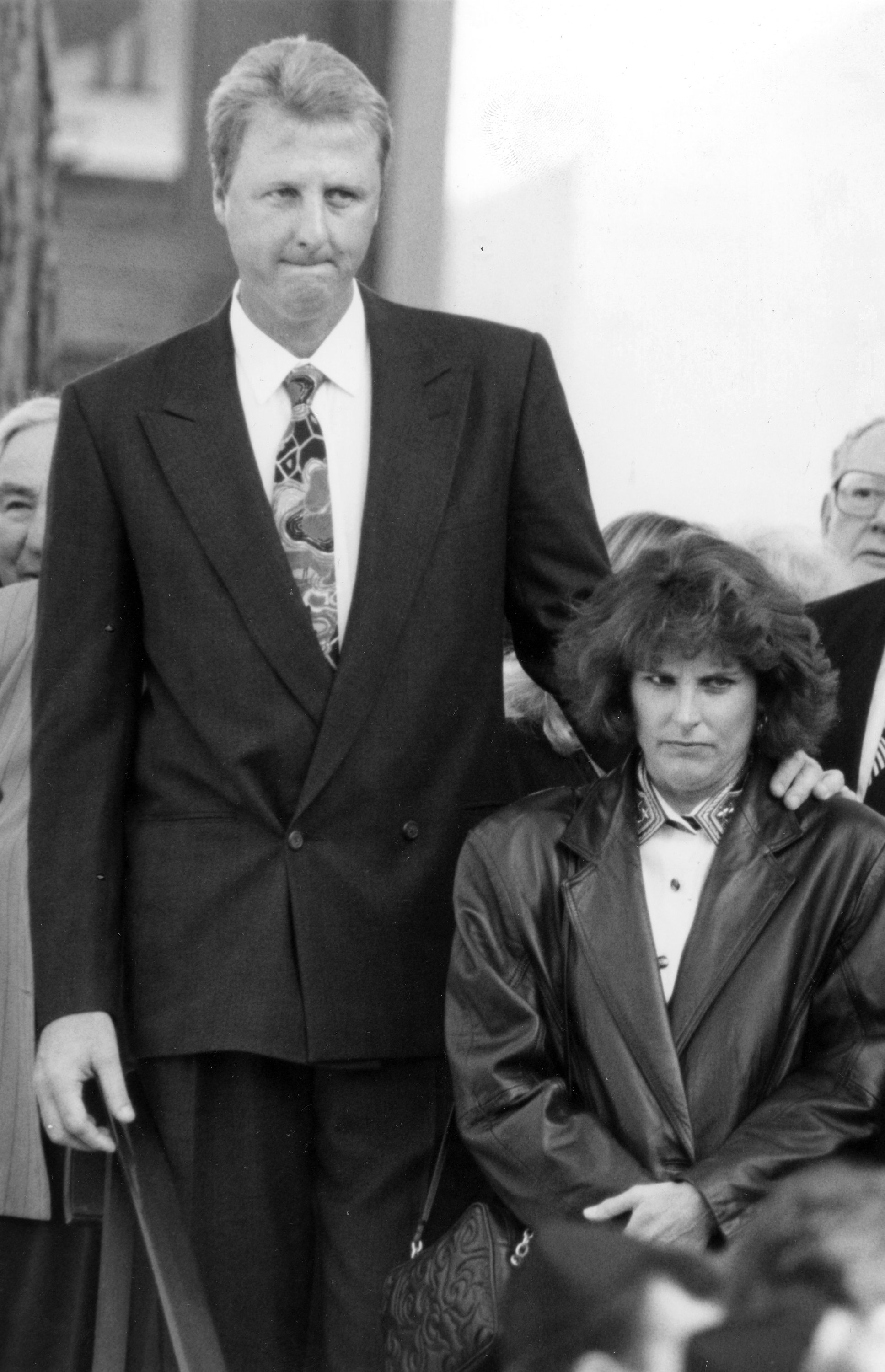 Larry Bird and his wife Dinah are photographed during Bob Woolf's funeral in the Brookline neighborhood of Boston, in 1993.