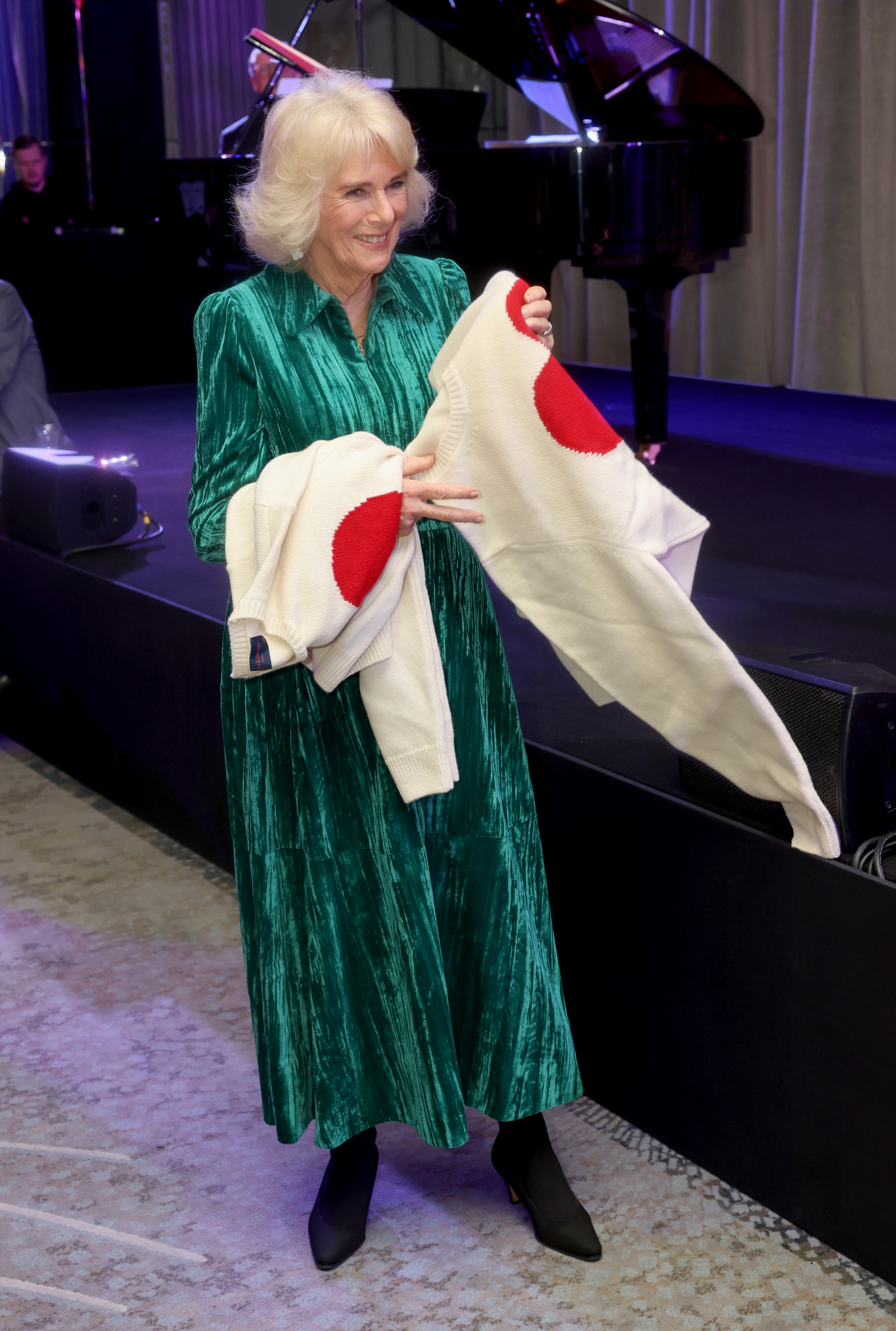 Queen Camilla receives sweaters during the "Celebration Of Shakespeare" event at Grosvenor House in London on February 14, 2024. | Source: Getty Images