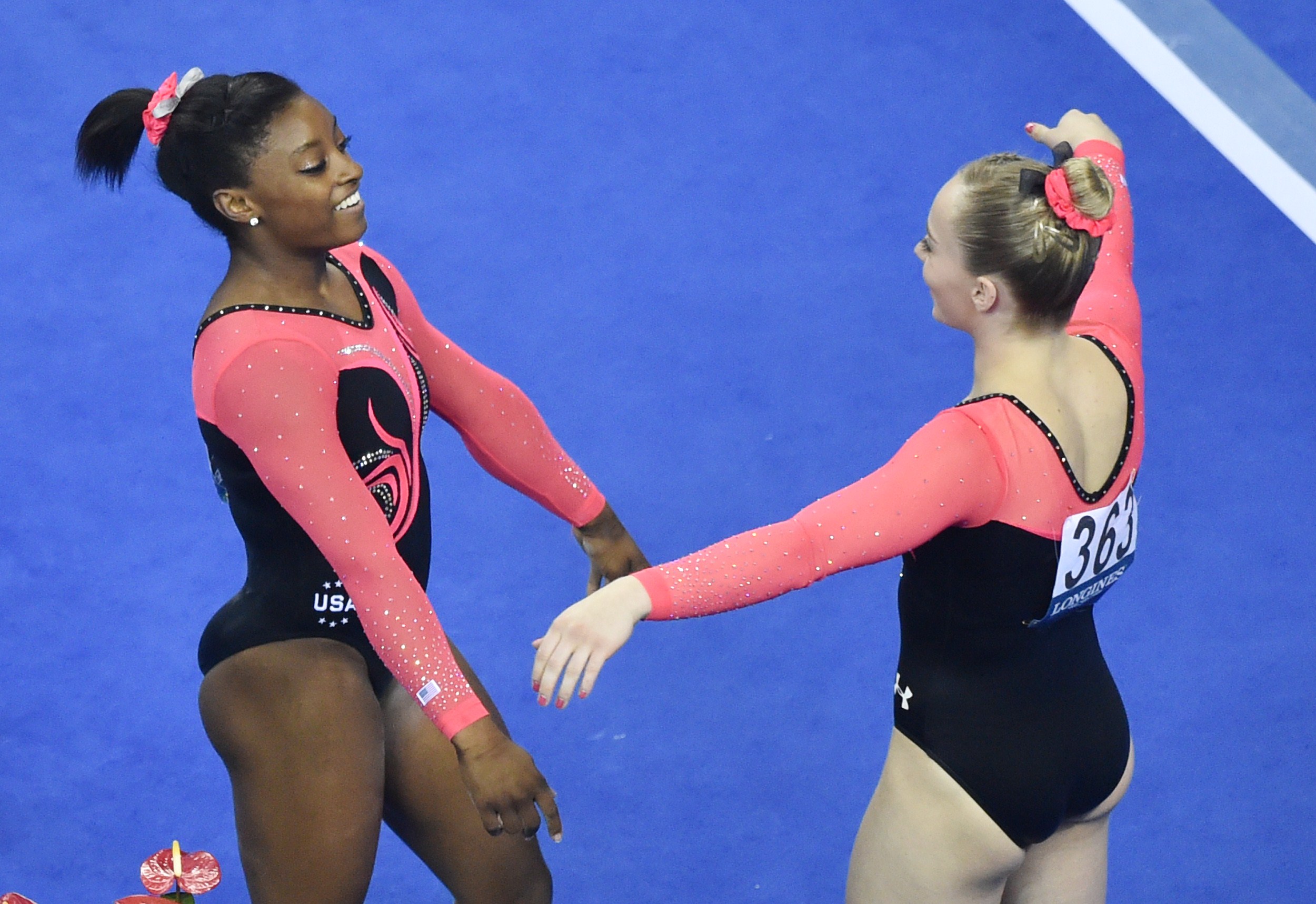 Simone Biles and MyKayla Skinner during the women's floor exercise final at the gymnastics world championships in Nanning, on October 12, 2014. | Source: Getty Images