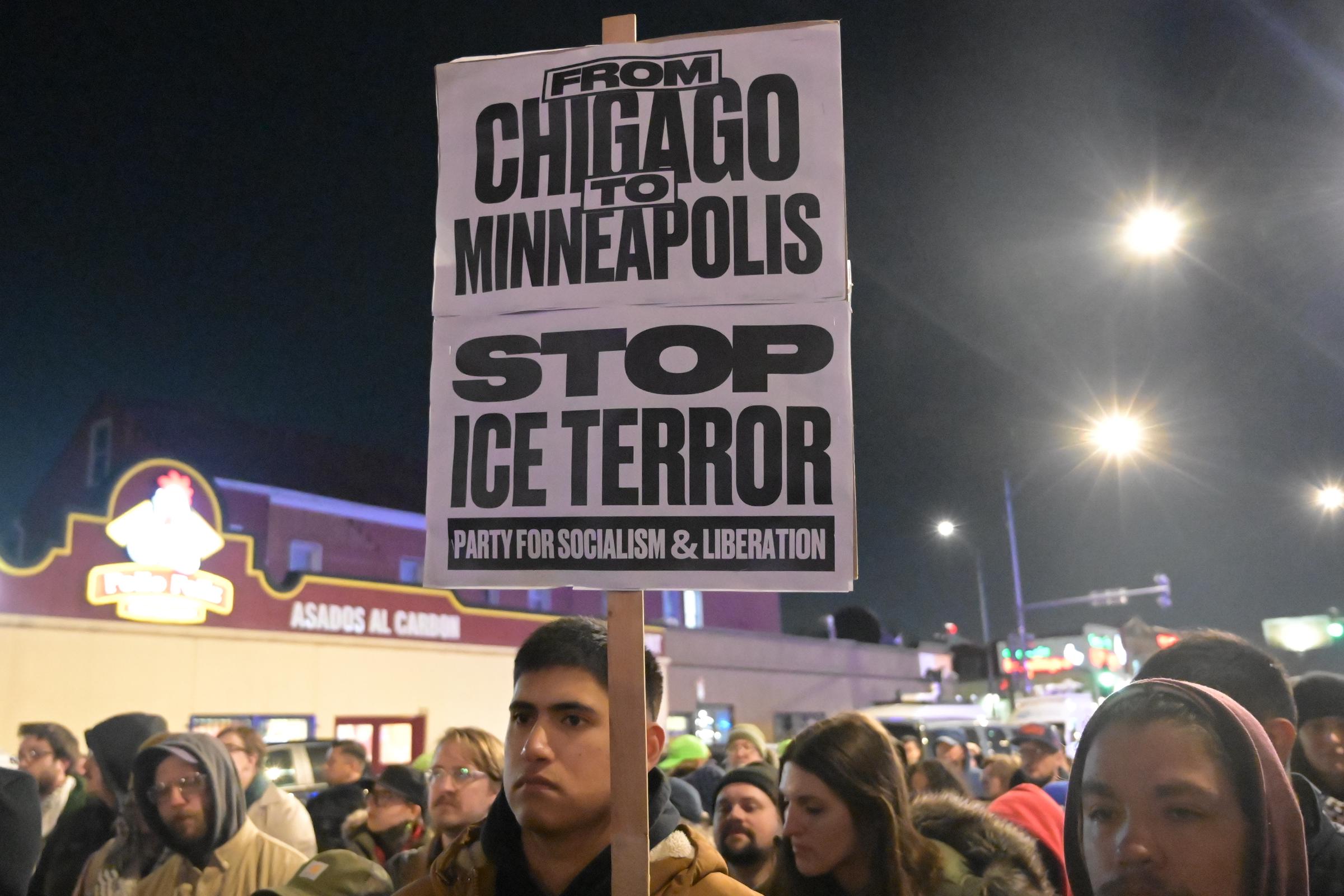 A demonstrator holds a sign reading 'From Chicago to Minneapolis Stop ICE Terror' during an emergency vigil and protest for Renee Good in the Little Village in Chicago, Illinois on January 7, 2026. | Source: Getty Images