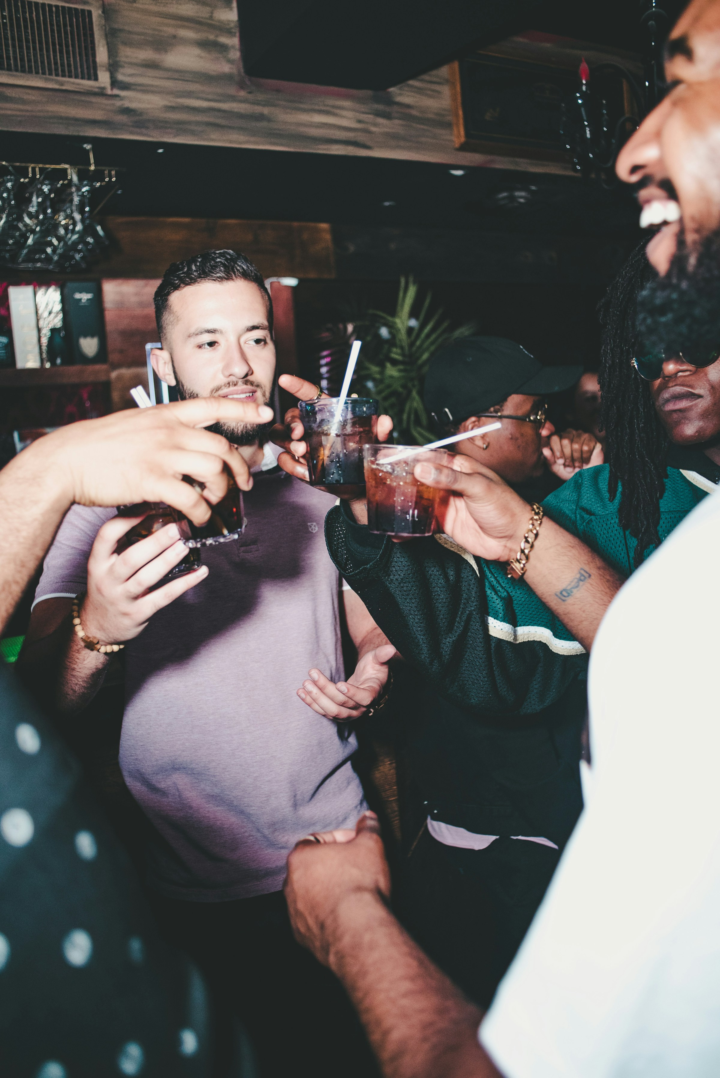 A group of men holding drinks | Source: Unsplash