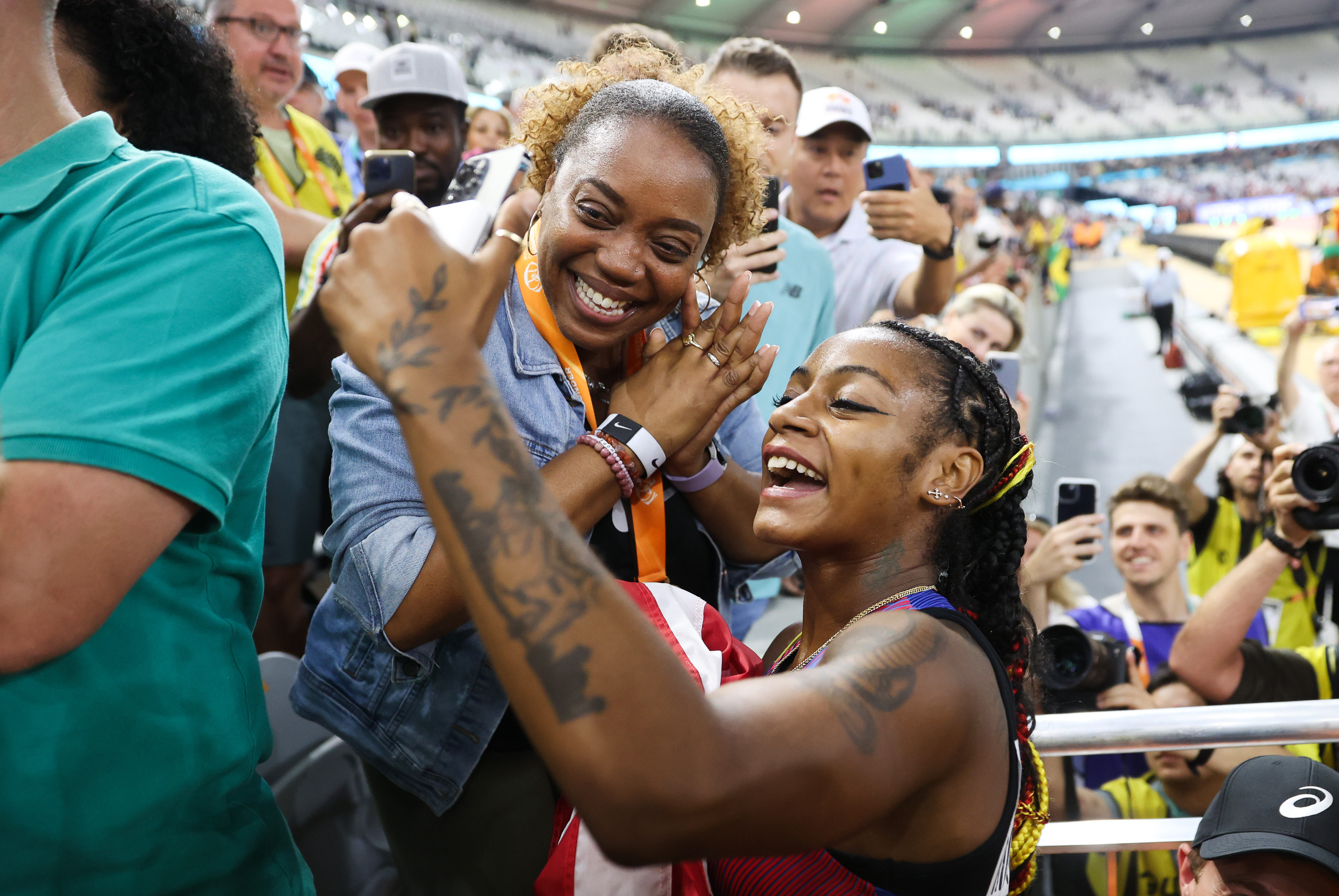 Sha'Carri Richardson celebrates winning the Women's 100m Final with Shayaria Richardson during the World Athletics Championships Budapest 2023 on August 21, 2023, in Budapest, Hungary. | Source: Getty Images