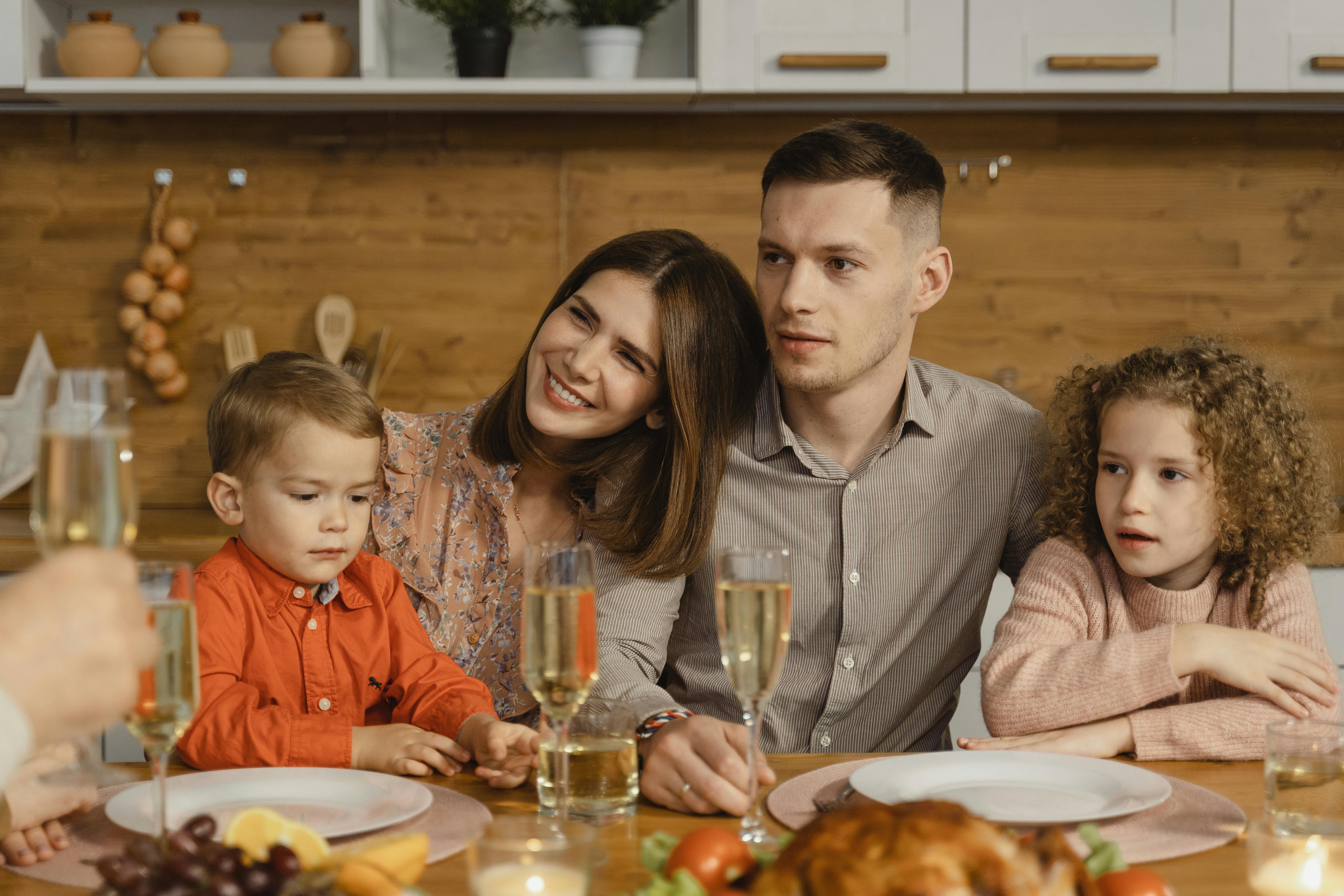 A family of four sitting together for a meal | Source: Pexels