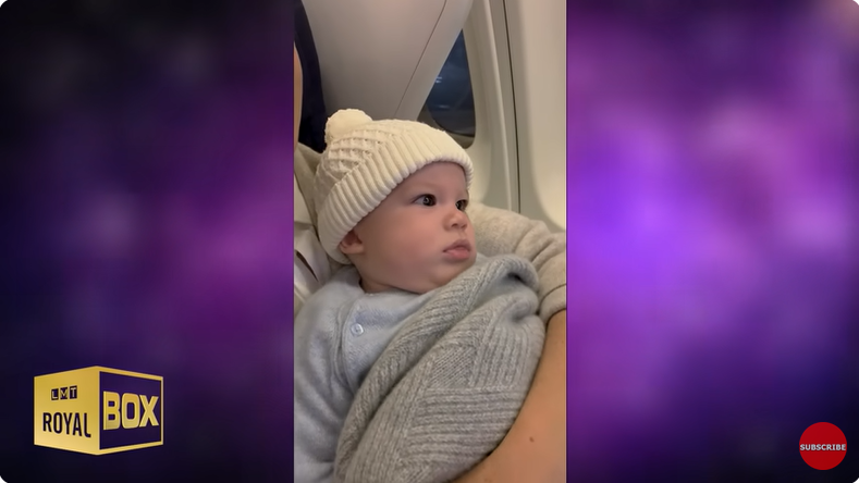Meghan, Duchess of Sussex holds Archie Harrison Mountbatten-Windsor on a plane ride from a YouTube video dated December 15, 2022 | Source: Youtube/@LMT