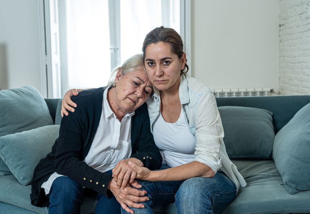 A mother and daughter duo comforting one another | Source: Shutterstock