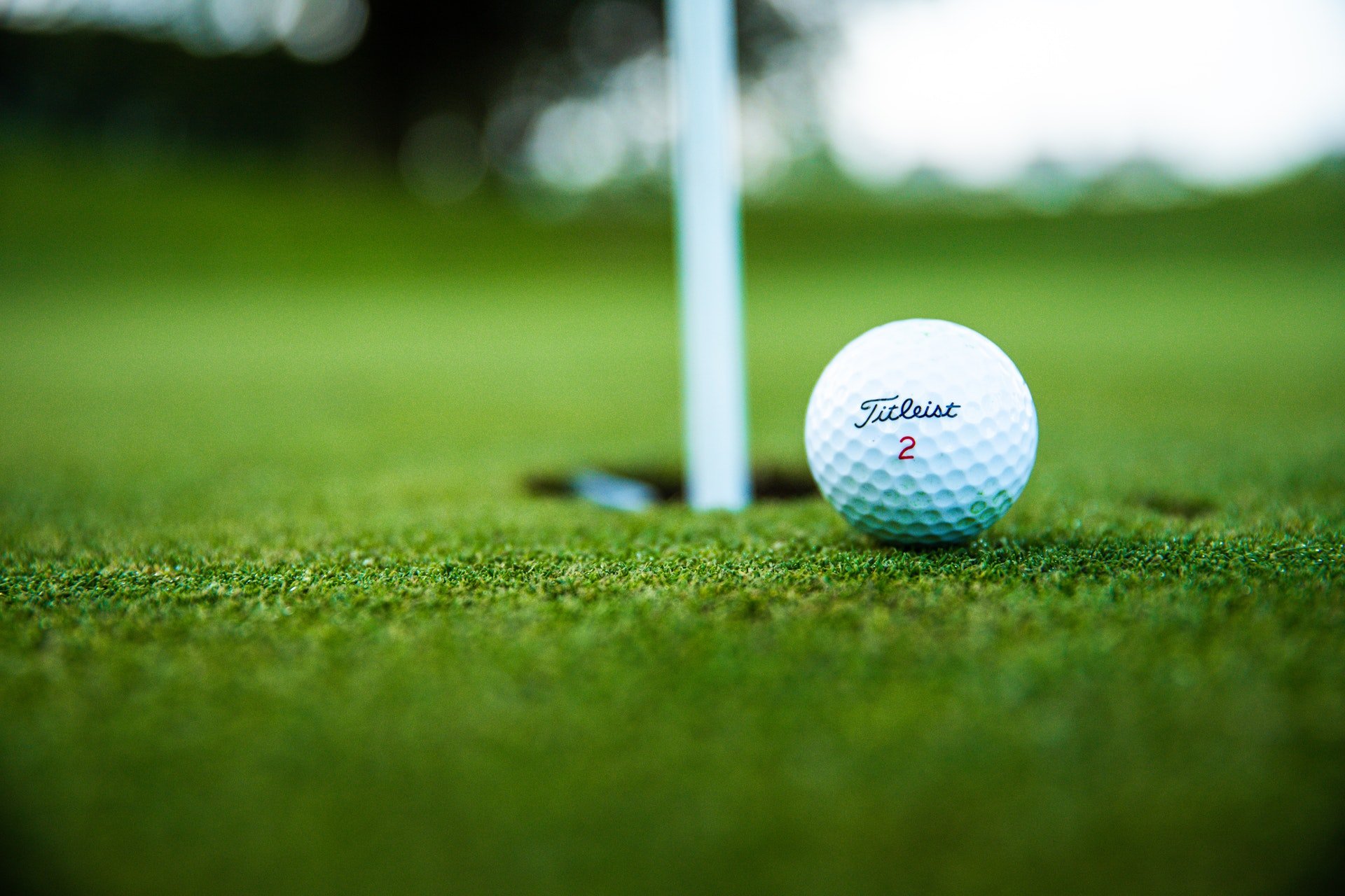 A picture of a golf ball close to a hole on a golf course in Westminster, United States | Photo: Pexels/Thomas Ward