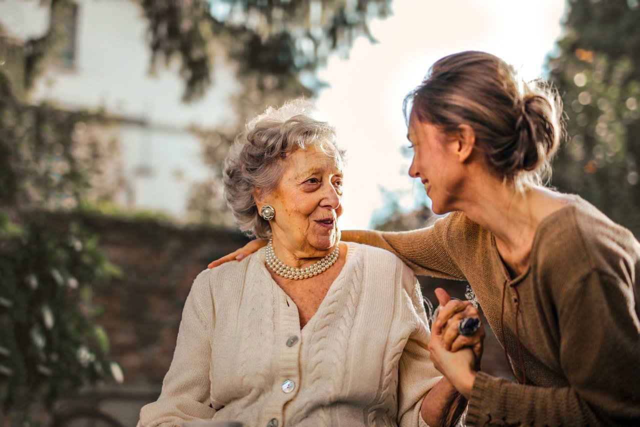 Woman sitting with elderly mother | Source: Pexels