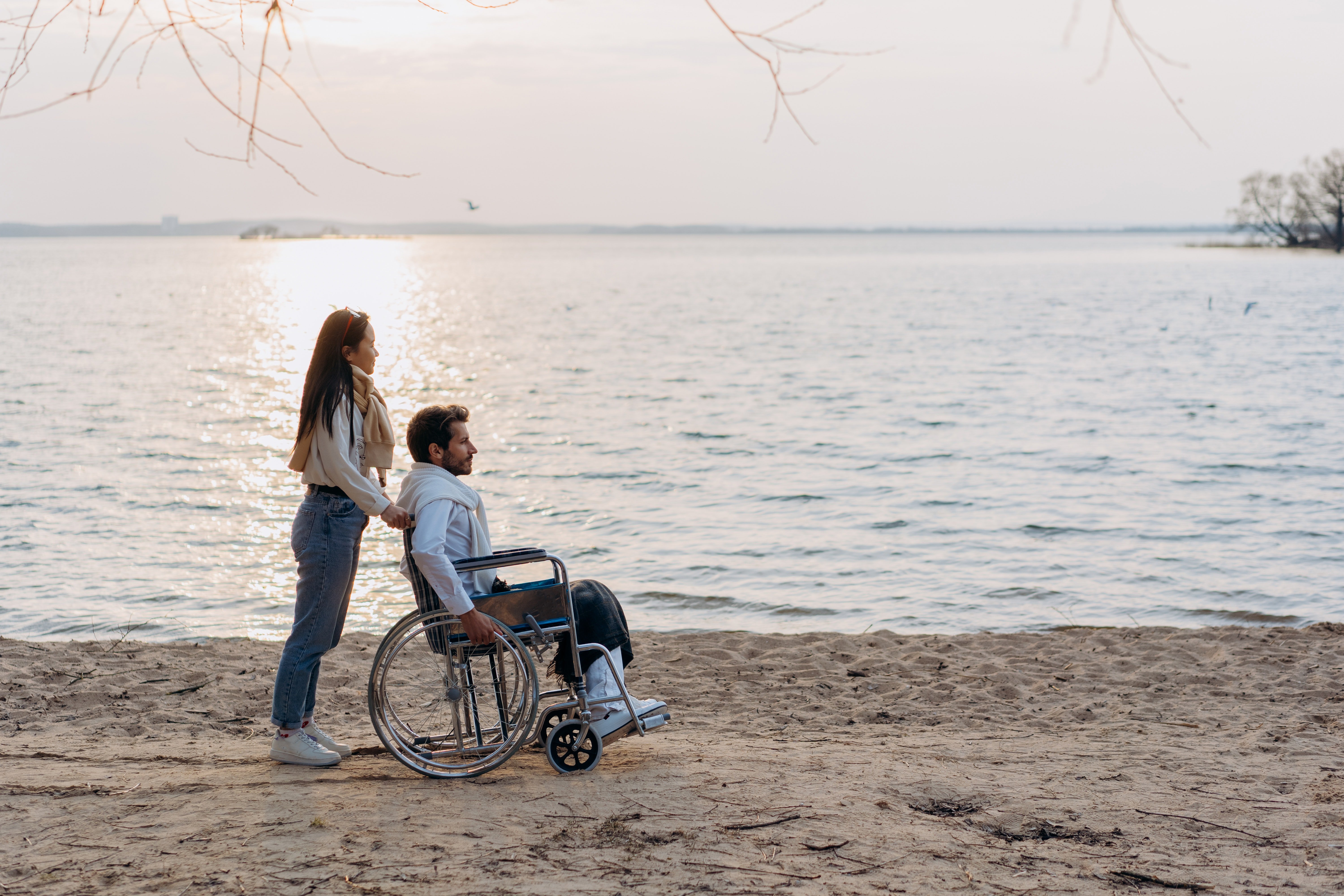 A woman with a man on a wheelchair  | Source: Pexels