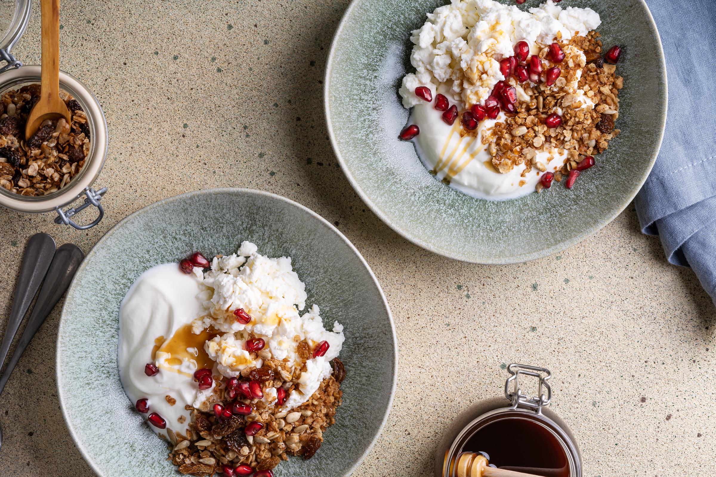Homemade granola with cottage cheese, kefir, pomegranate, and honey in bowl | Source: Getty Images