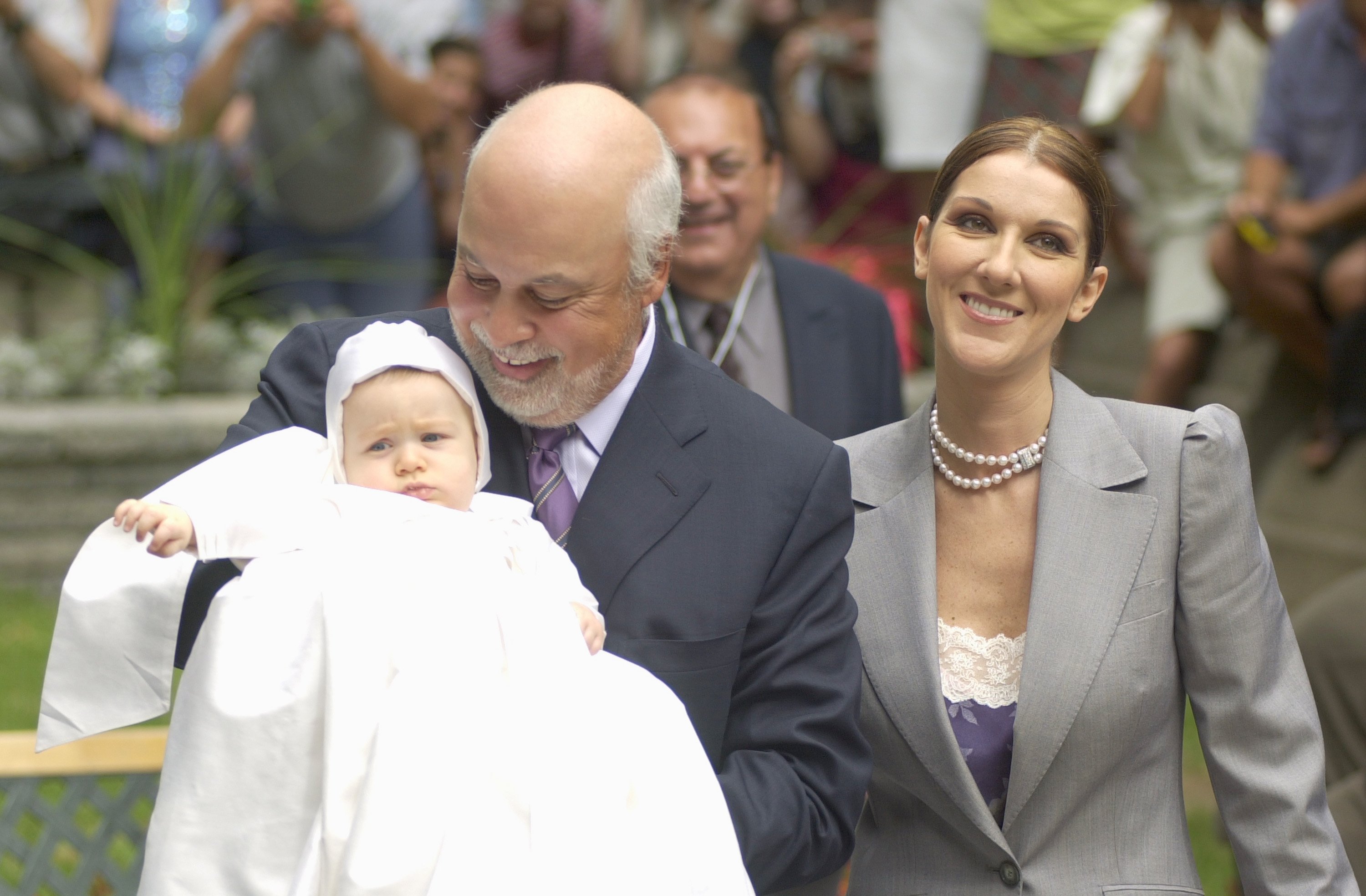 Pop star Celine Dion pictured with her husband, Rene Angelil, who holds their son Rene-Charles on July 25, 2001 at the chapel of the Notre-Dame Basilica in Montreal, Quebec. / Source: Getty Images