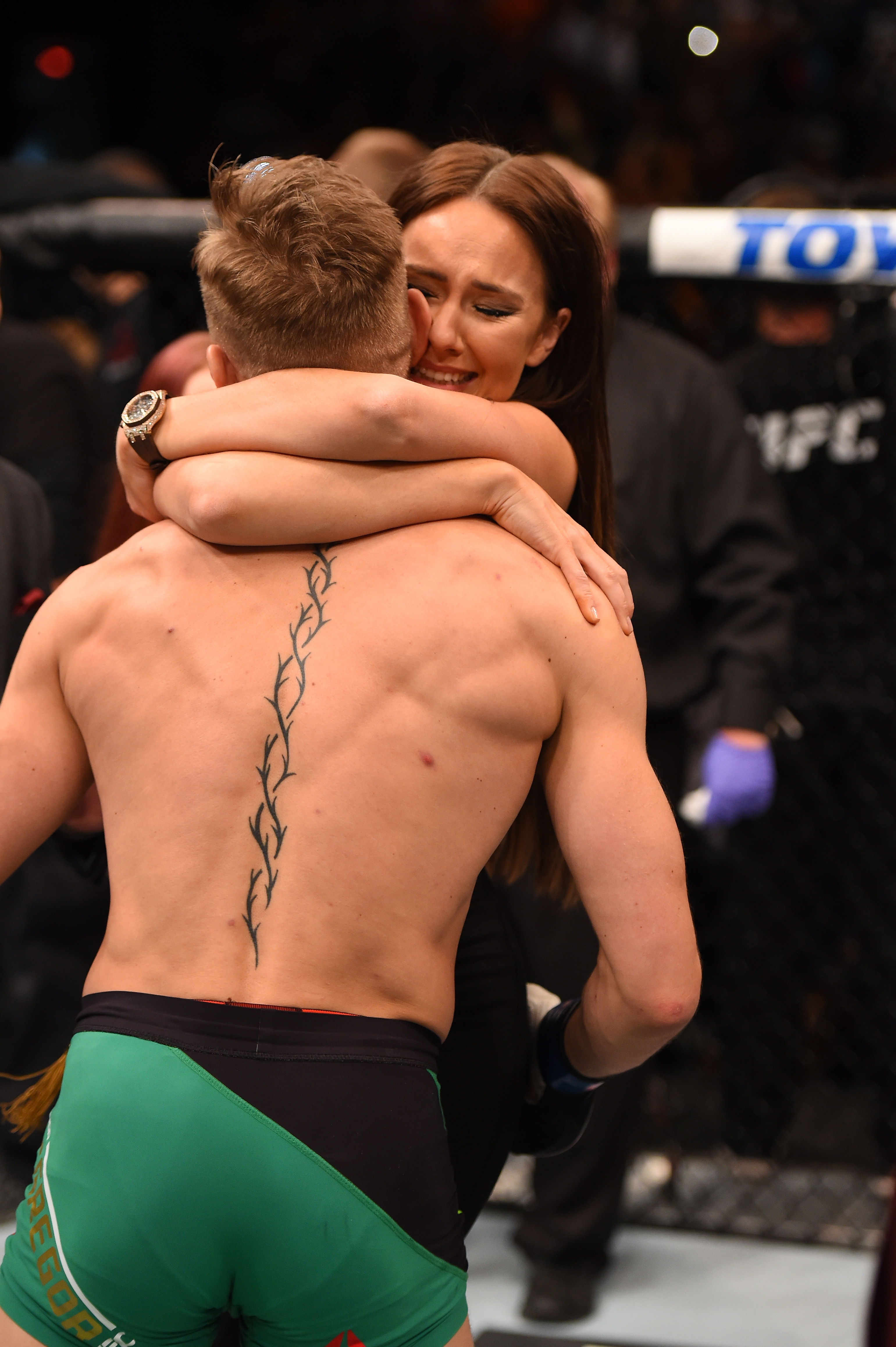 Conor McGregor and Dee Devlin embracing after he defeated Jose Aldo of Brazil in the UFC featherweight championship during the UFC 194 event on December 12, 2015, in Las Vegas, Nevada. | Source: Getty Images