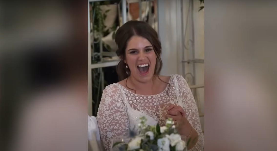 Newlywed bride Katie laughing during her husband's speech | Source: YouTube / Daily Record