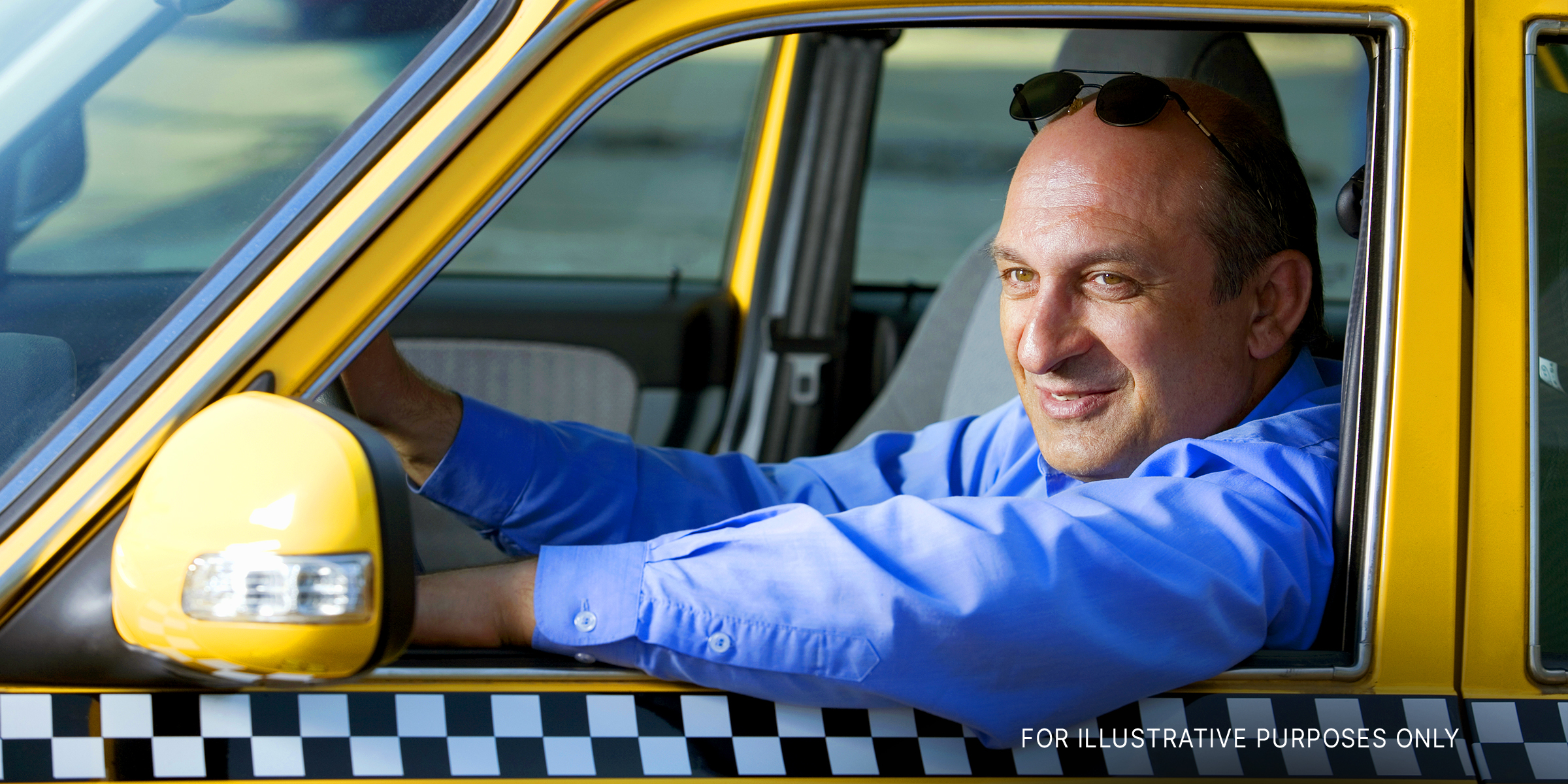 Male taxi driver in yellow taxi | Source: Shutterstock