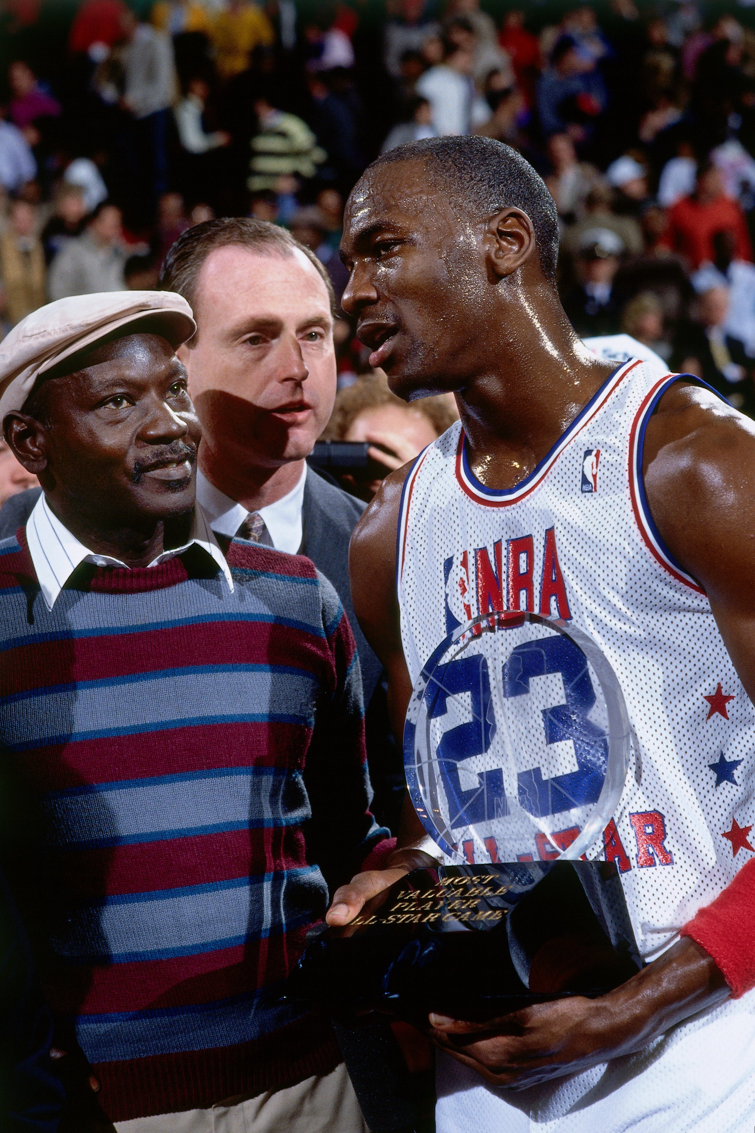 Michael Jordan #23 of the Eastern Conference All Stars stands on the court with his father James Jordan after receiving the MVP award in 1988. | Photo: Getty Images