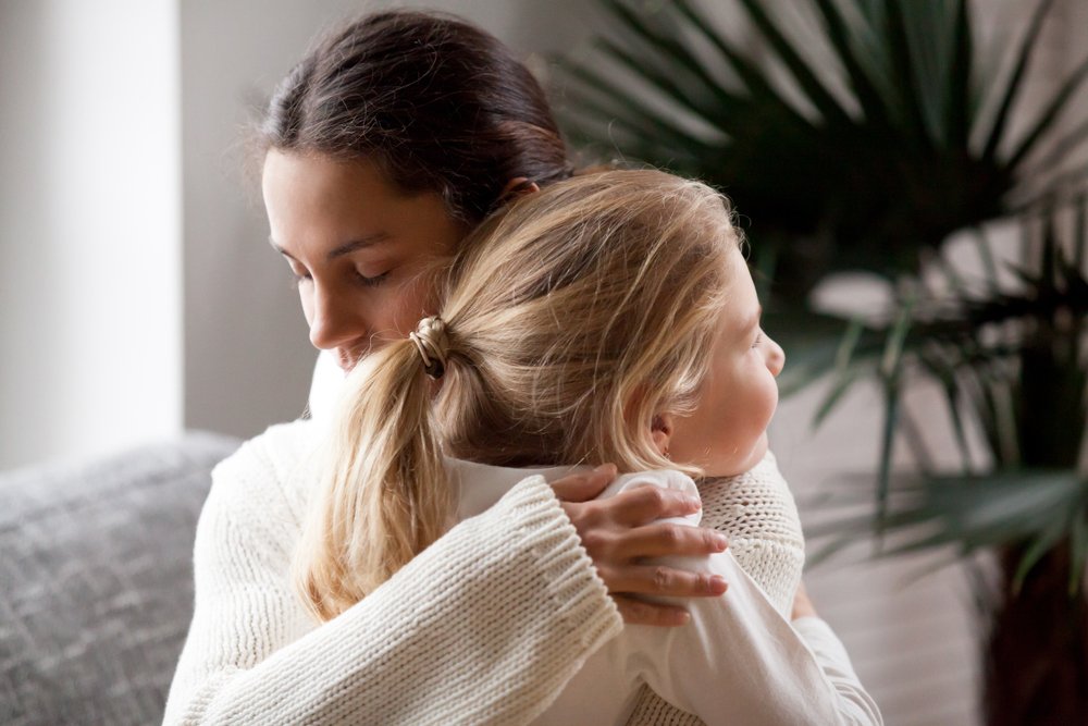 A loving mother embracing her adopted child. | Photo: Shutterstock