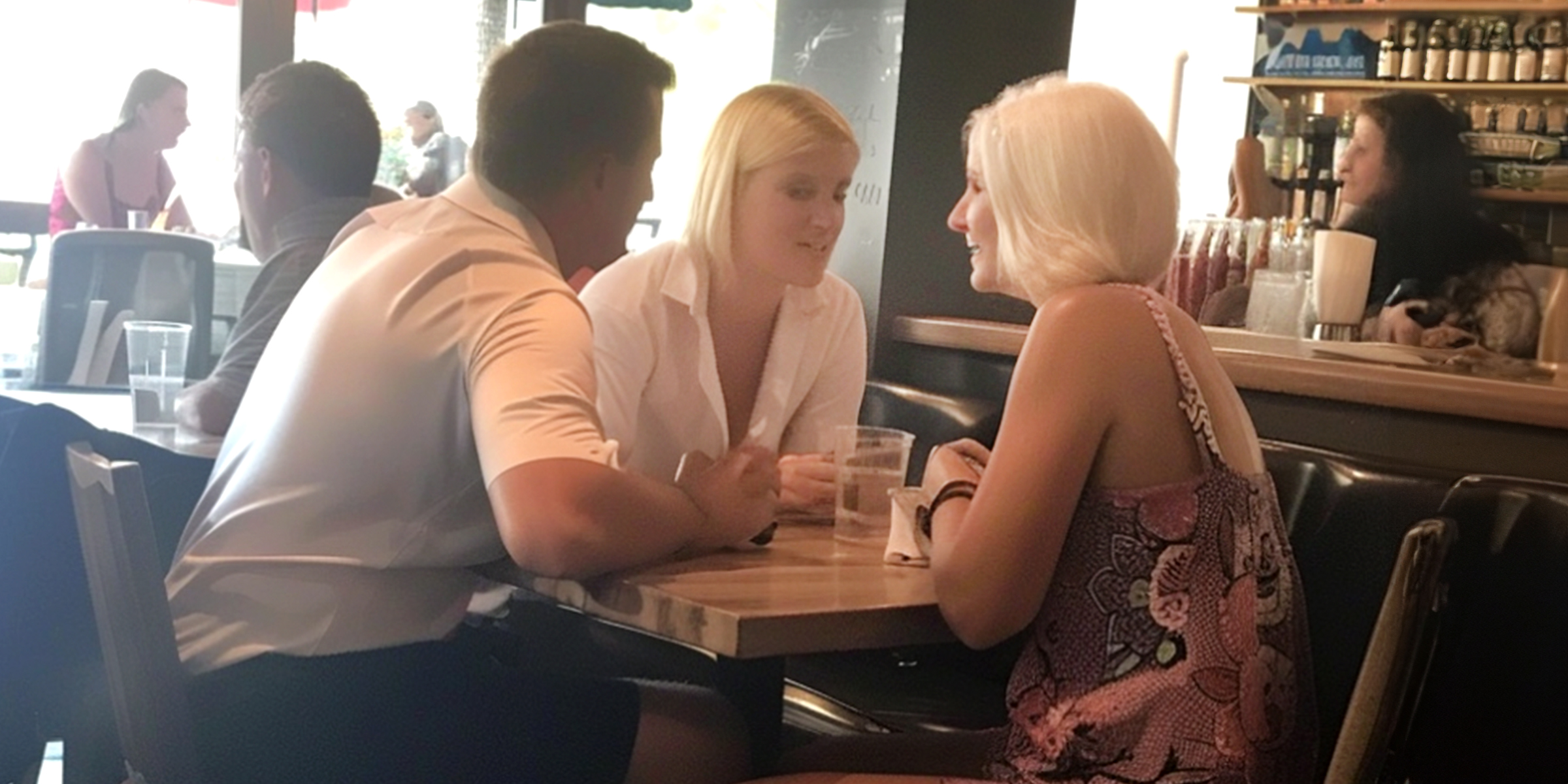 Two women and a man seated in a restaurant | Source: Amomama