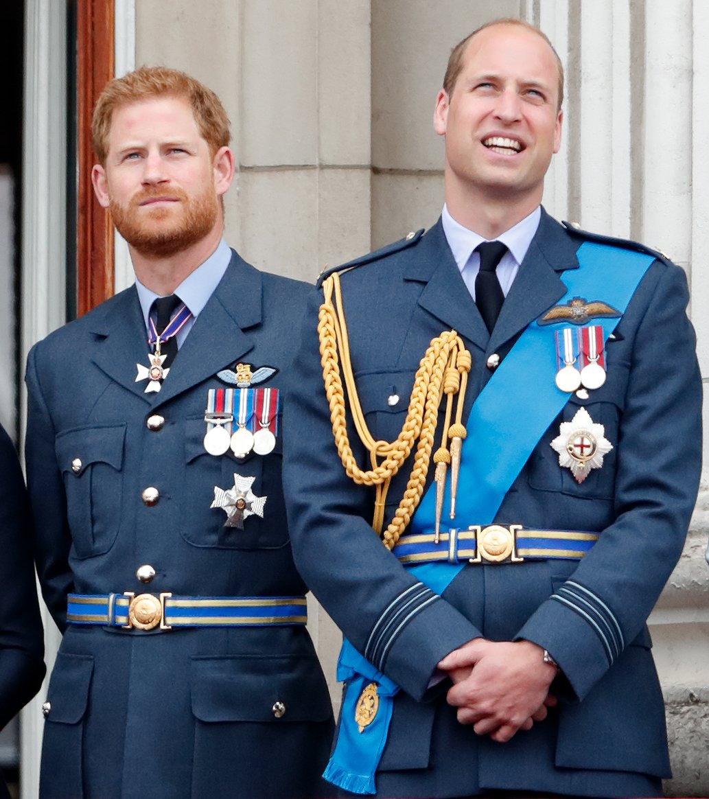 Prince Harry and Prince William look up at a flypast during the Royal Air Force centenary event at the Buckingham Palace on July 10, 2018 | Photo: Getty Images