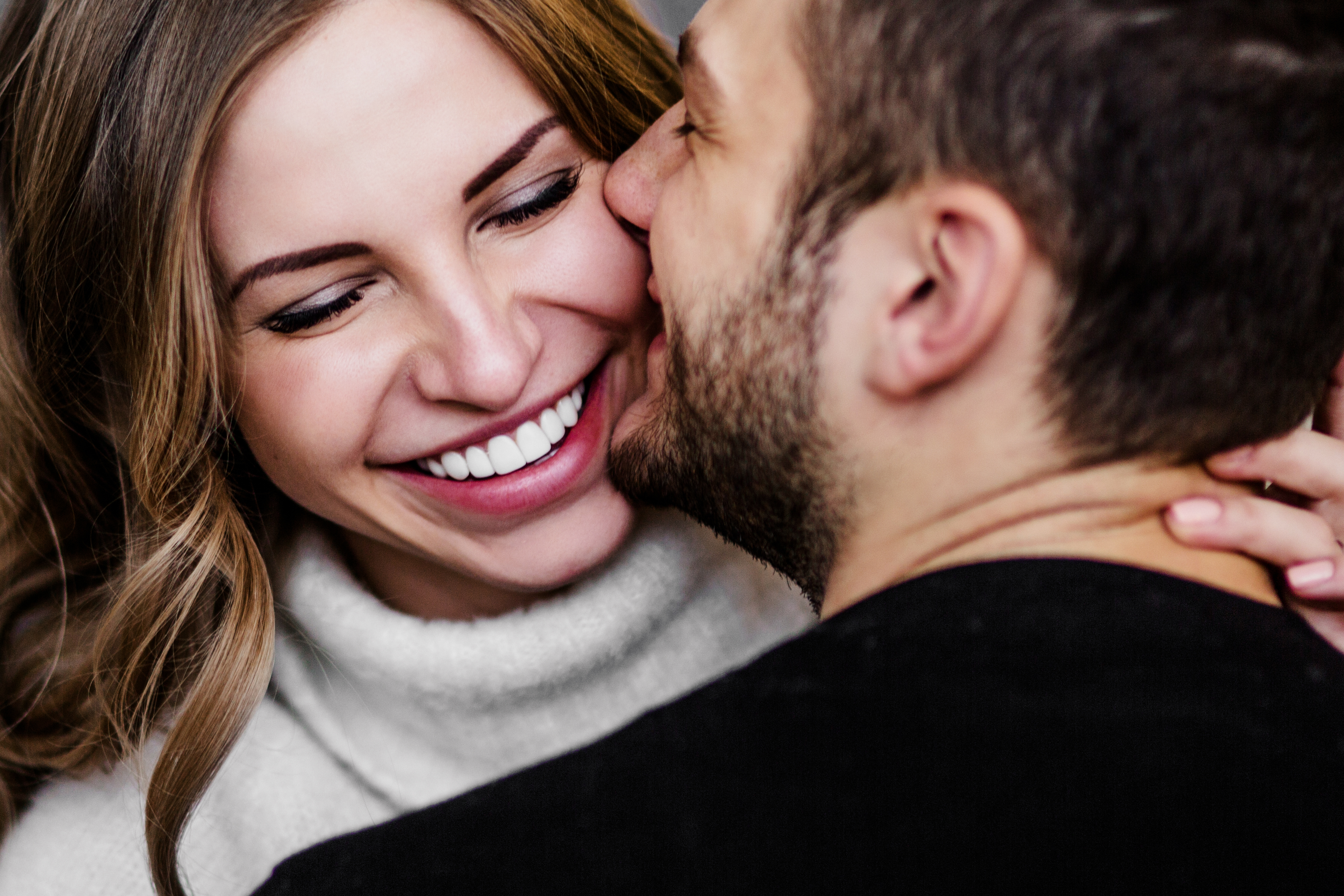 A man kissing his partner on the cheek | Source: Shutterstock