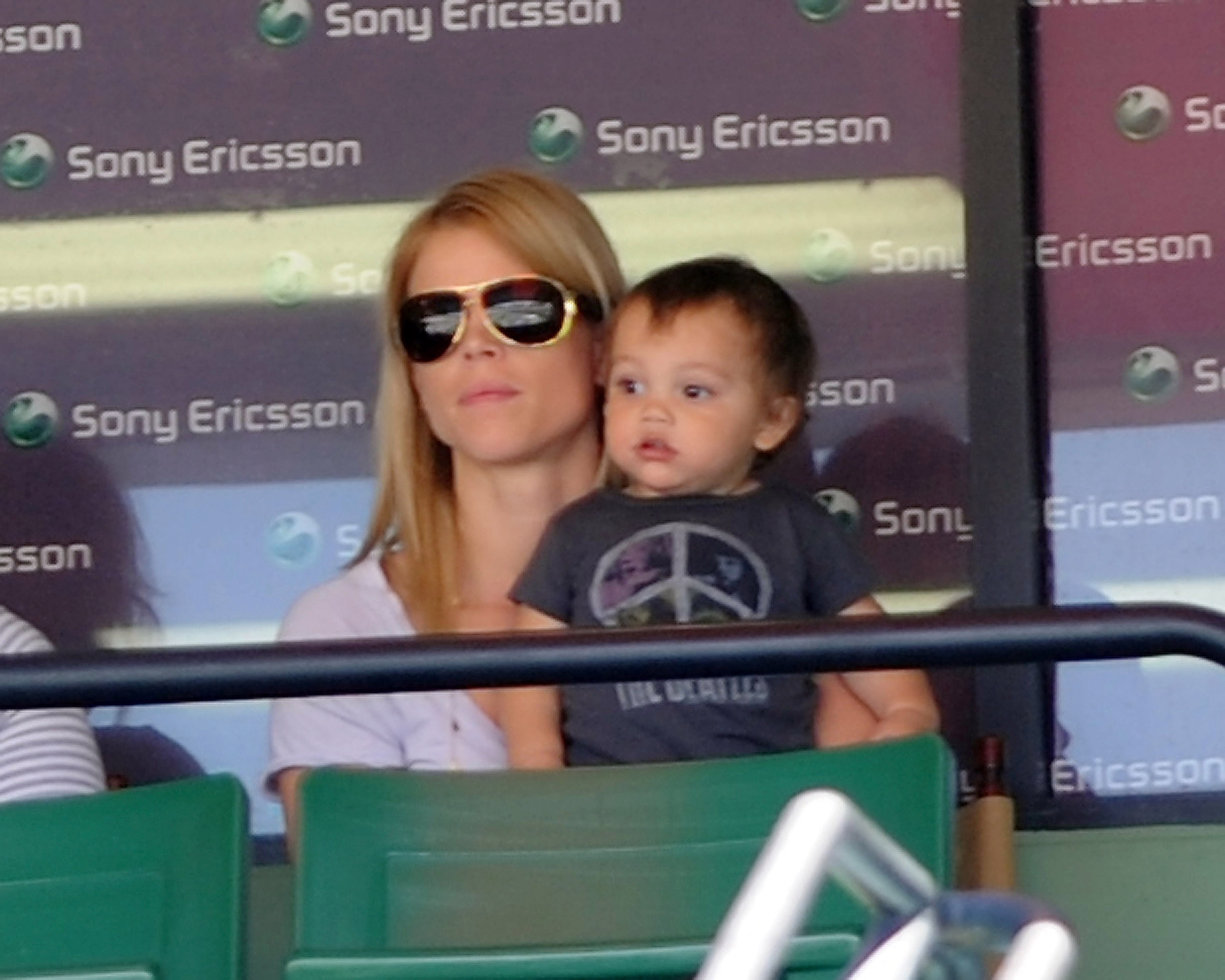 Elin Nordegren holds her son Charlie Woods while watching tennis at the Sony Ericsson Open in Key Biscayne, Florida, on April 2, 2010. A rare public moment between mother and child.