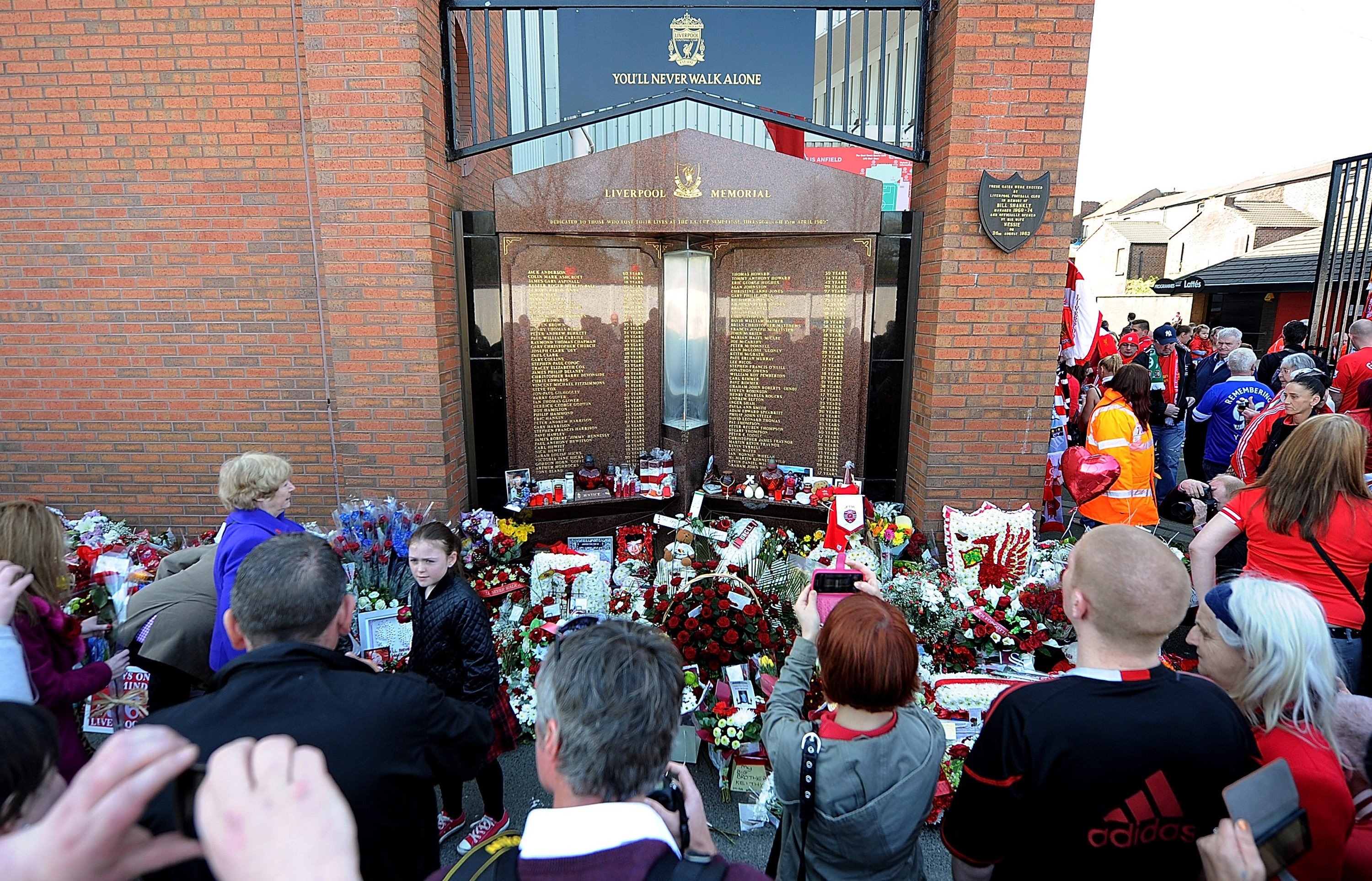 Fans gather at the Hillsborough memorial during the memorial service marking the 25th anniversary of the Hillsborough Disaster, at Anfield Stadium on April 15, 2014 in Liverpool, England. | Source: Getty Images