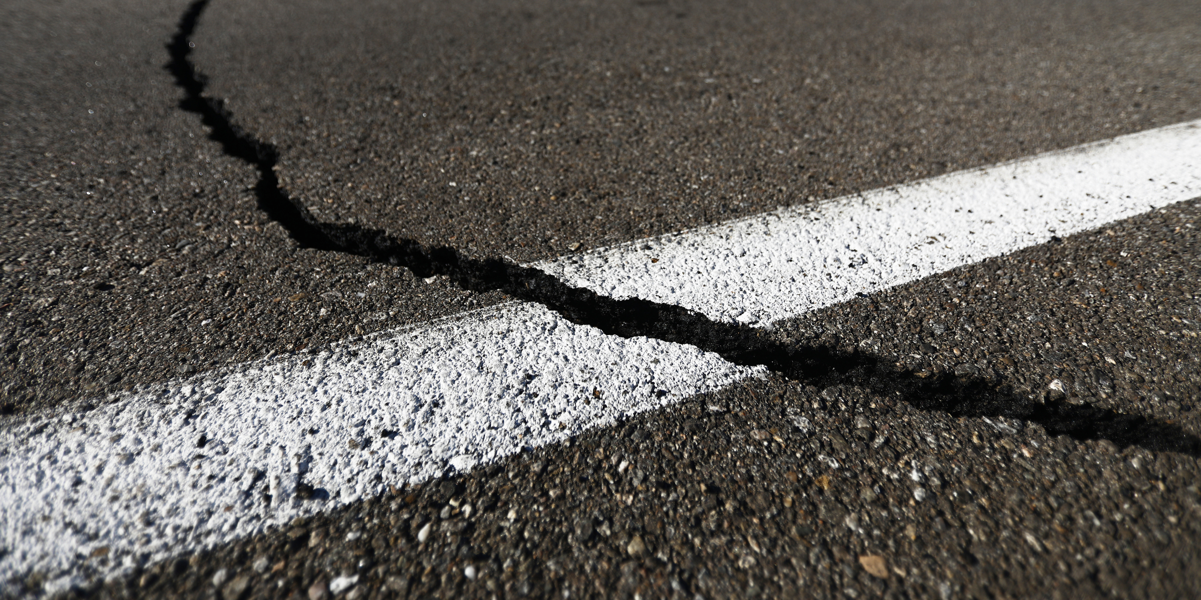 A close-up of a cracked asphalt road | Source: Getty Images