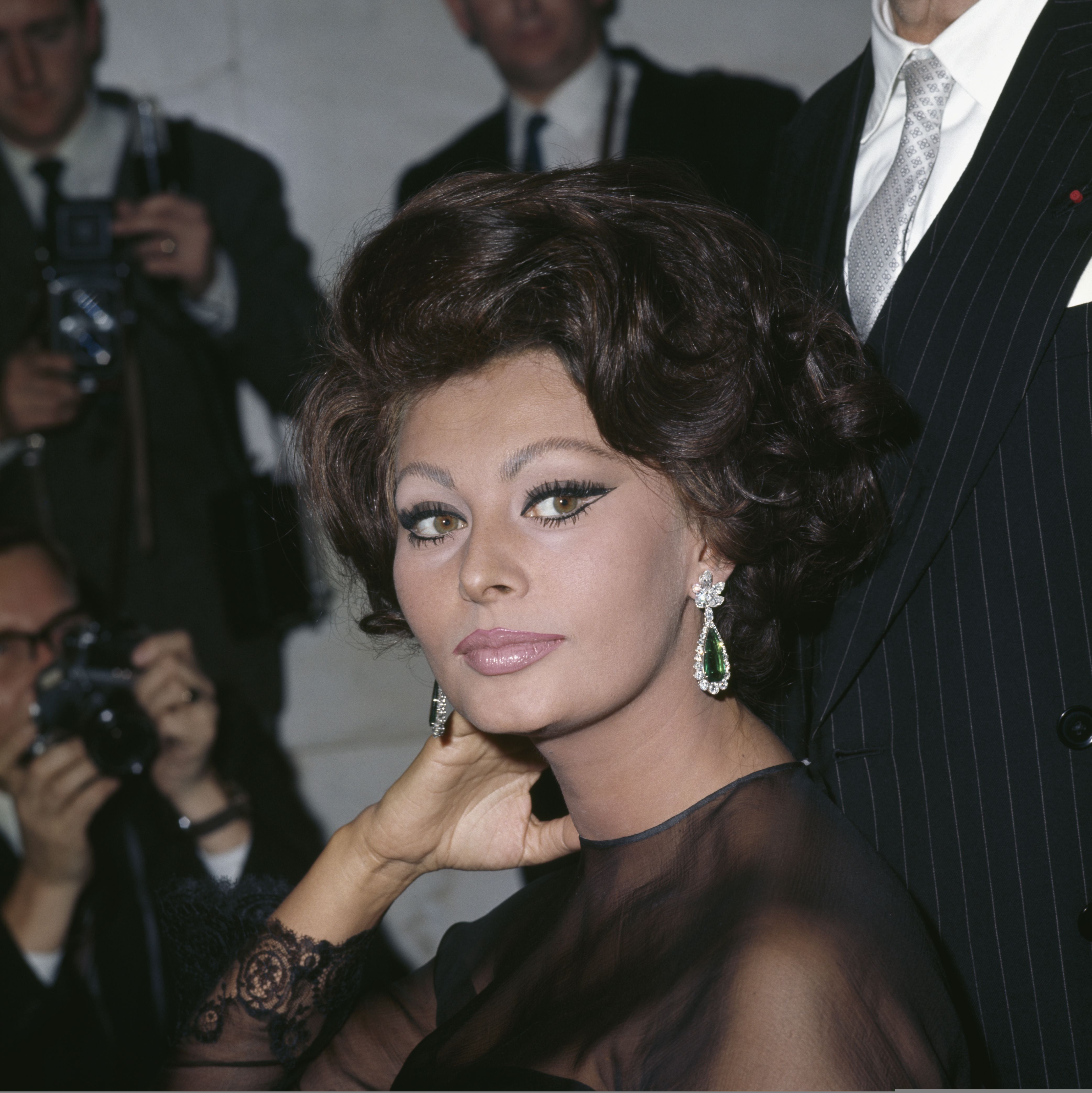 Sophia Loren pose pour les photographes à l'hôtel Savoy, à Londres. | Photo : Getty Images