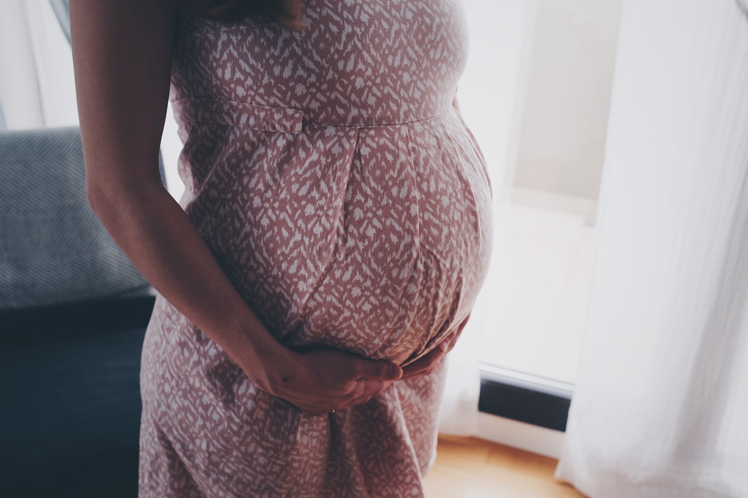 A pregnant woman holding her belly. | Source: Unsplash