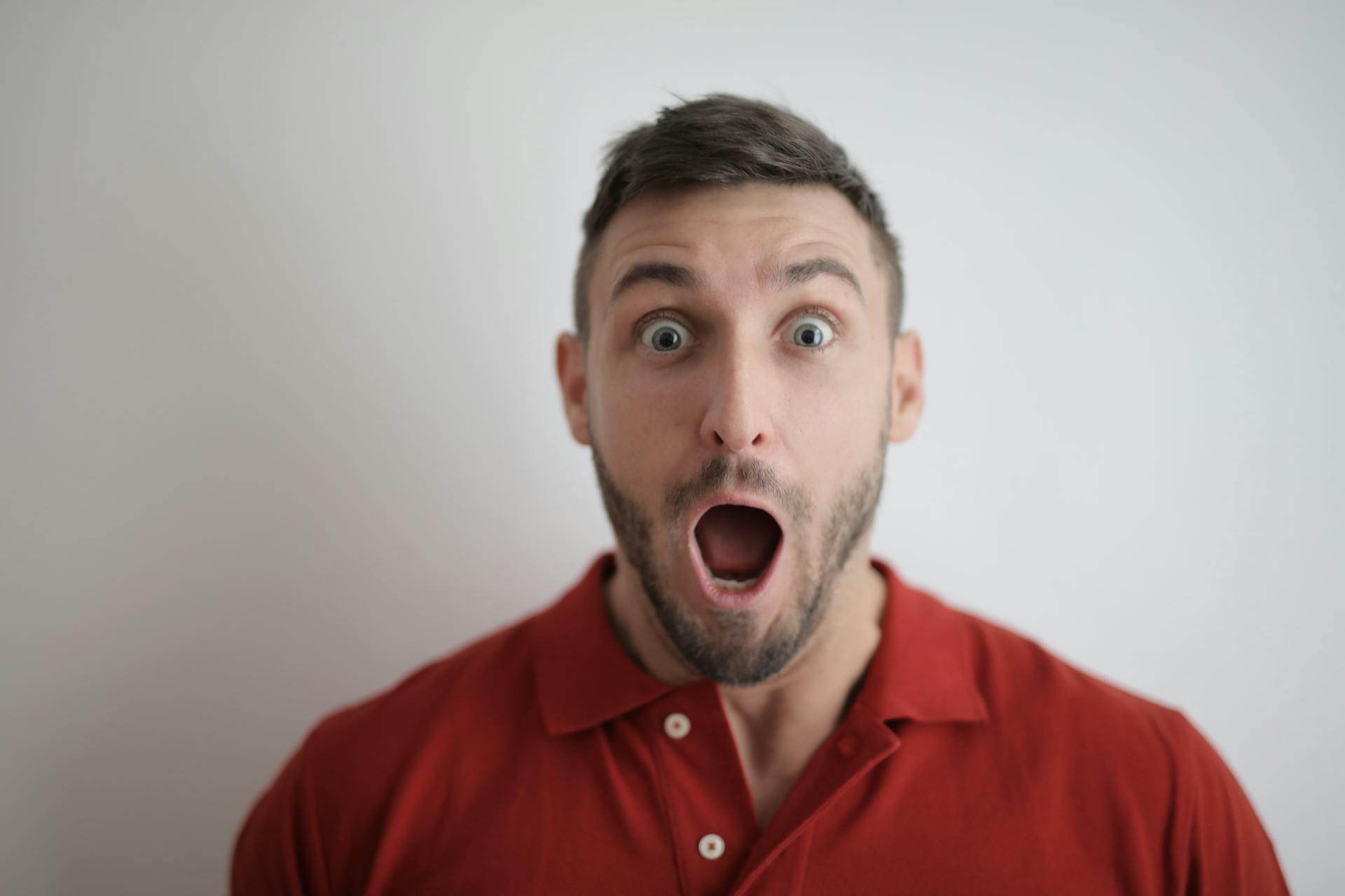 A shocked man in red | Source: Pexels