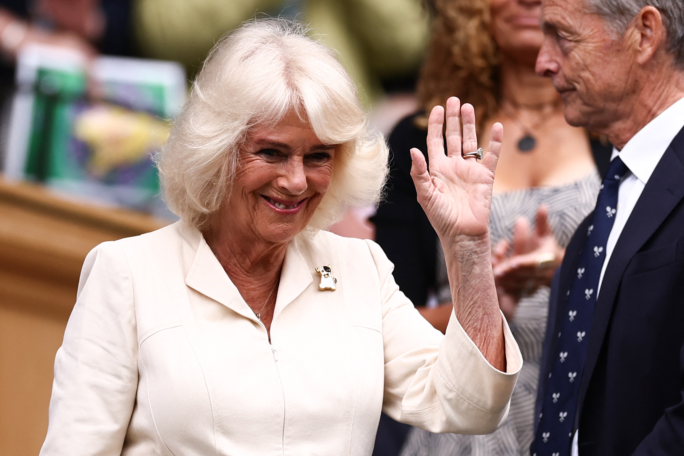 Queen Camilla waving to the public during the Wimbledon tennis championship on July 10, 2024 | Source: Getty Images