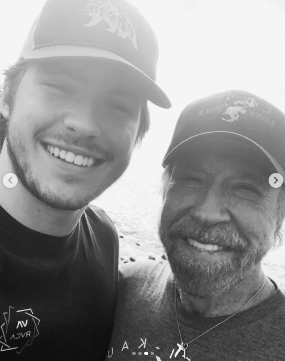 Chuck Norris and his son Dakota share a smiling moment together, as posted on March 19, 2026 | Source: Instagram/d.ak.ot.a
