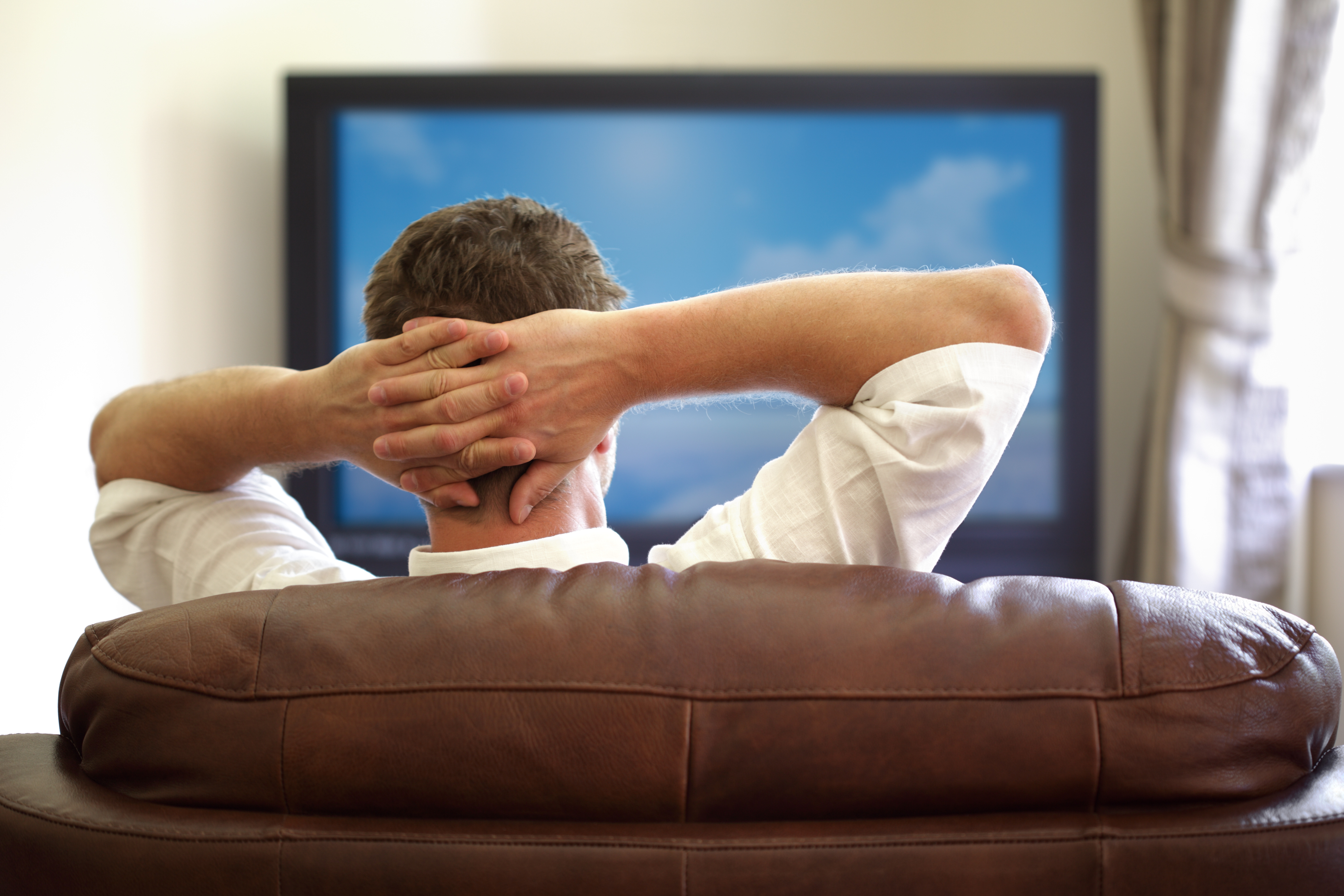A man watching TV | Source: Shutterstock