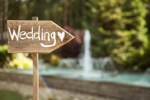 A signboard showing directions to a wedding. | Source: Shutterstock.
