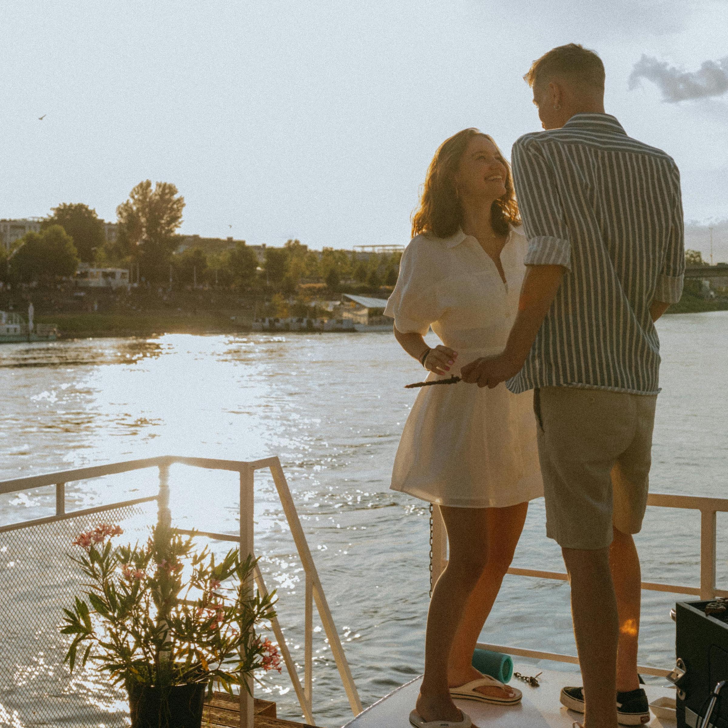 A woman smiling, talking to a man on the deck of a boat | Source: Pexels