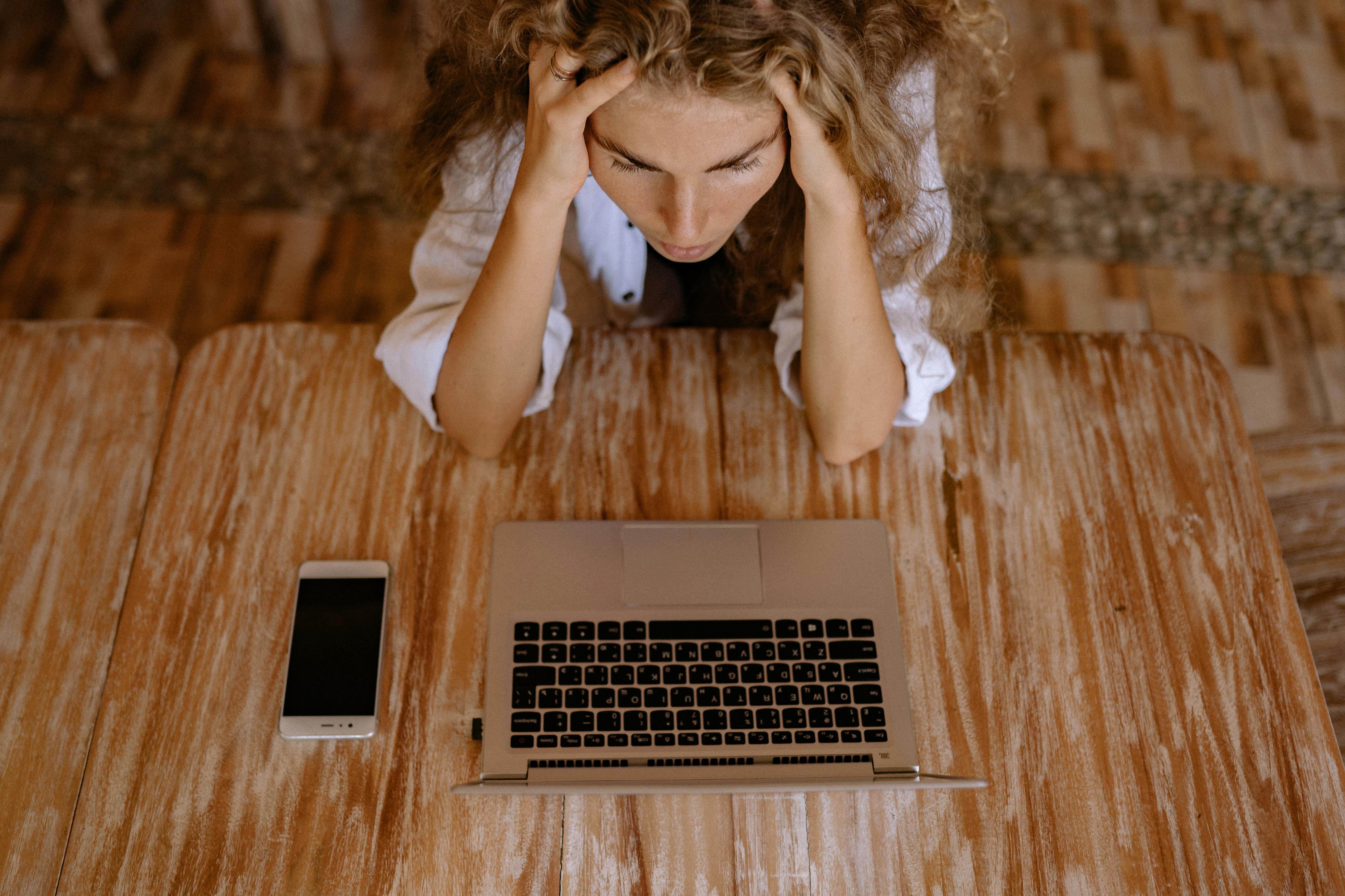 Shot of an upset woman and her laptop | Source: Pexels
