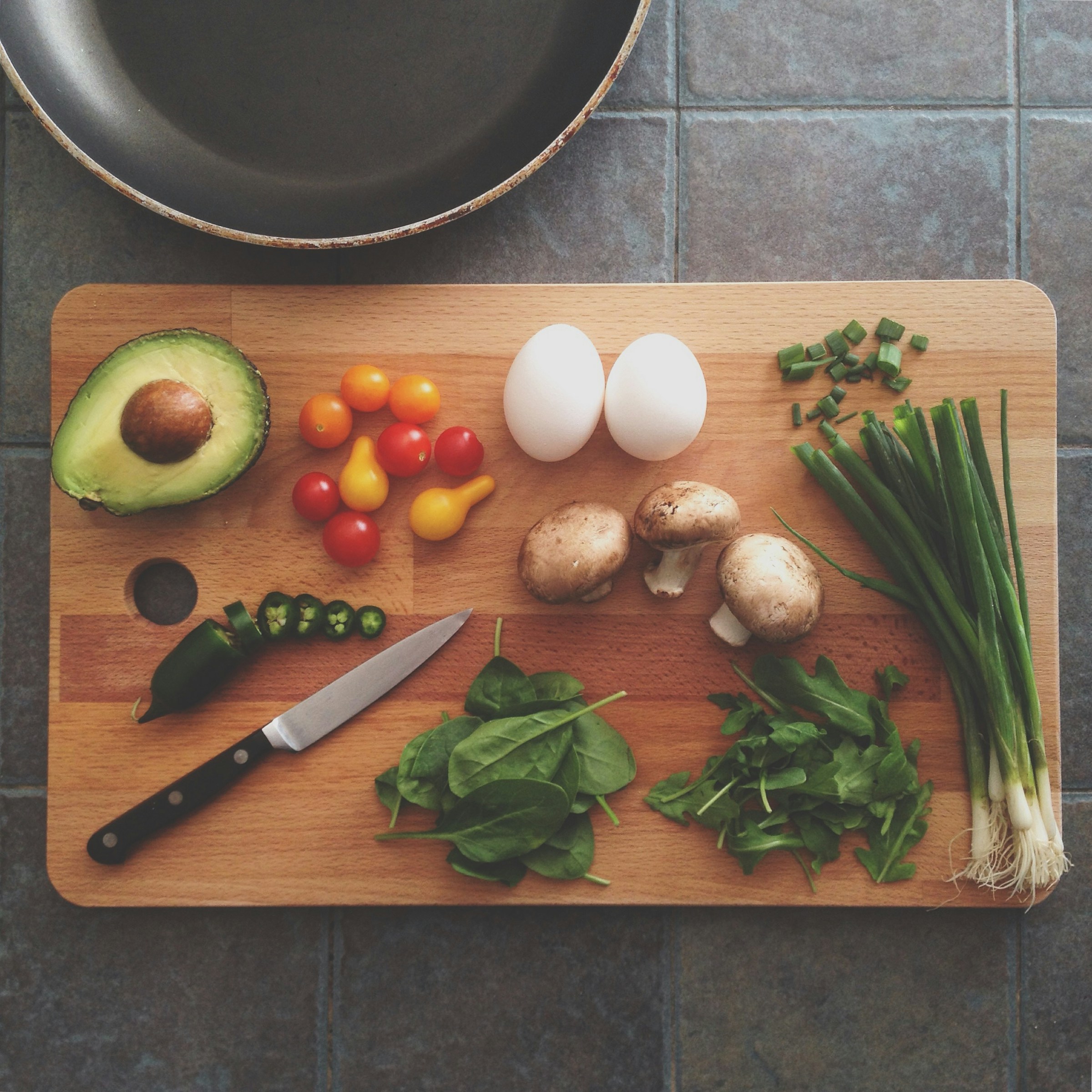 Vegetables and eggs on a cutting board | Source: Unsplash