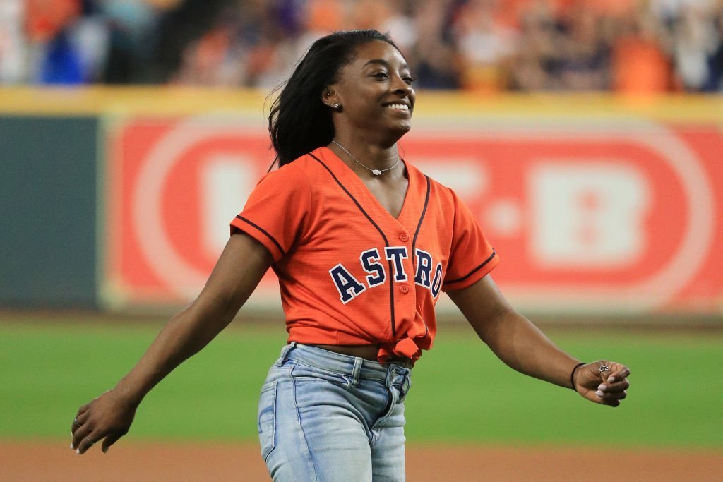 Gymnast Simone Biles throws out the ceremonial first pitch prior to Game Two of the 2019 World Series between the Houston Astros and the Washington Nationals at Minute Maid Park | Photo: Getty Images