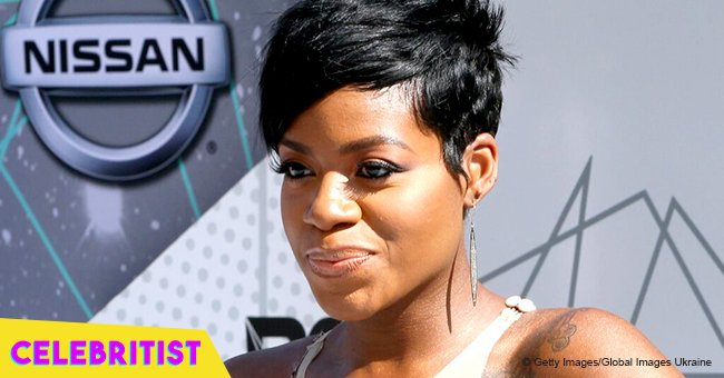 Fantasia shows off her curves in tight black & white dress on marriage anniversary in video