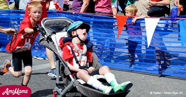 Disabled boy 'runs' marathons with a big assist from his brother
