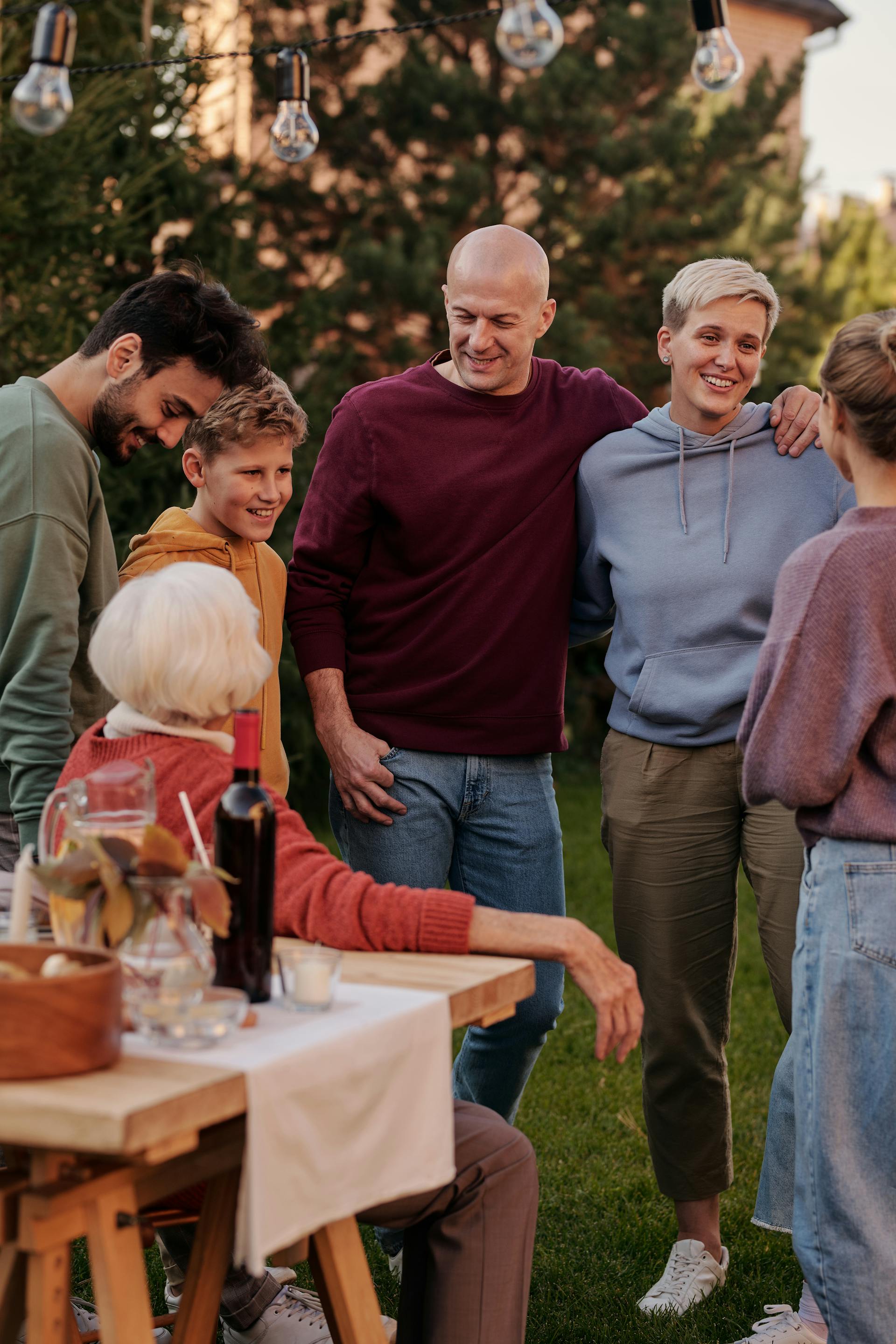 People standing around a table outside | Source: Pexels