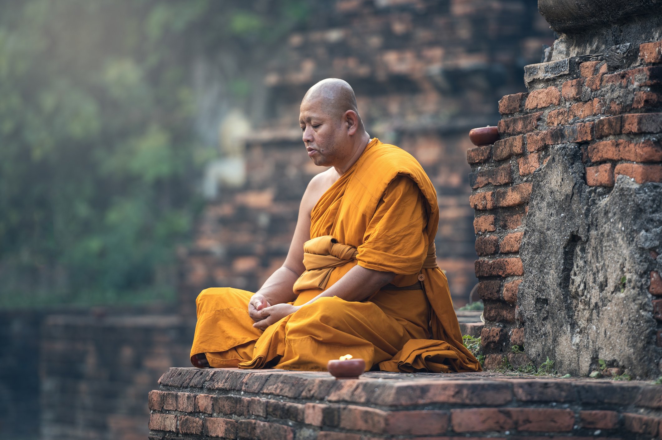 A portrait of a monk meditating in the temple. | Photo: Getty Images