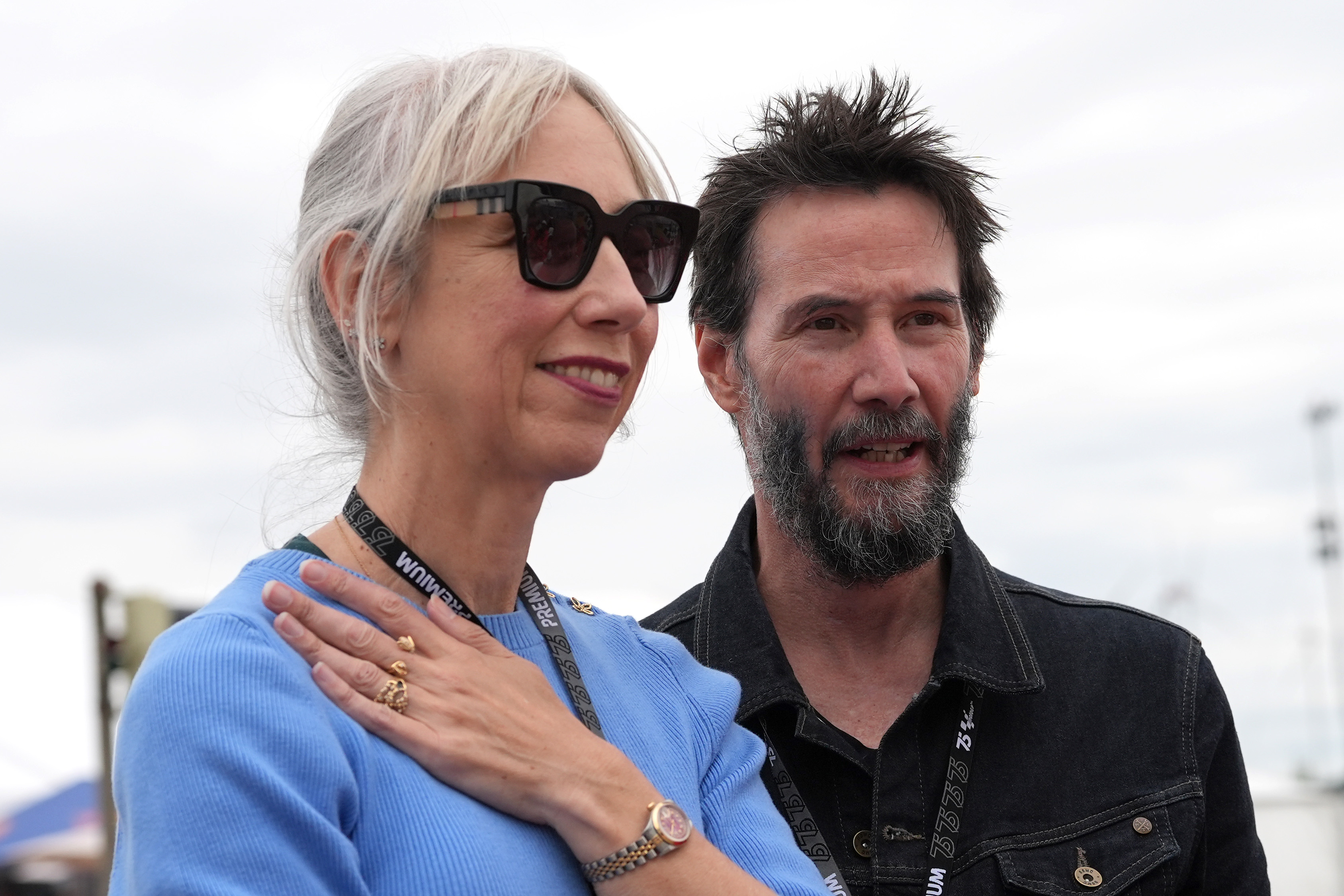 Alexandra Grant smiles beside Keanu Reeves at Sachsenring Circuit in Hohenstein-Ernstthal, Germany on July 7, 2024. | Source: Getty Images