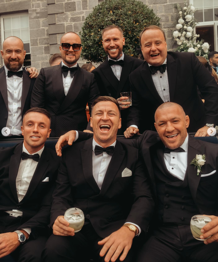 Conor McGregor and other guests smile as they enjoy their drinks at Terry Kavanagh and Erin McGregor's wedding on August 17, 2024 | Source: Instagram/thenotoriousmma