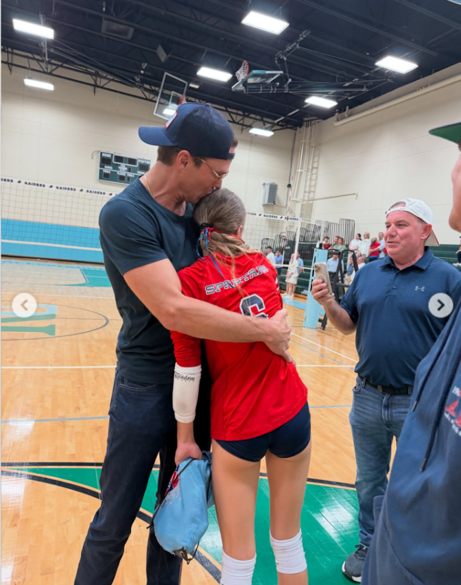 Tom Brady hugs his daughter Vivian after a sports' game, as seen from a post dated December 5, 2025. | Source: Instagram/tombrady