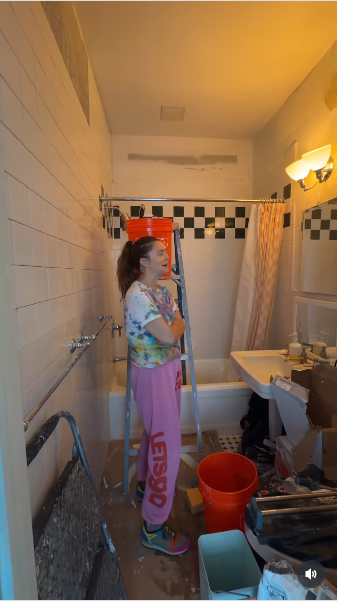 Drew Barrymore standing inside a bathroom filled with building supplies from a video posted on July 21, 2025 | Source: Instagram/drewbarrymore