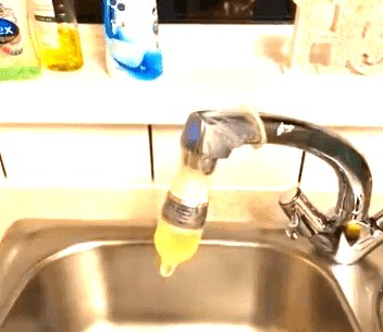Vinegar filled condom secured over a tap.| Photo: YouTube/Royal Magazine Az