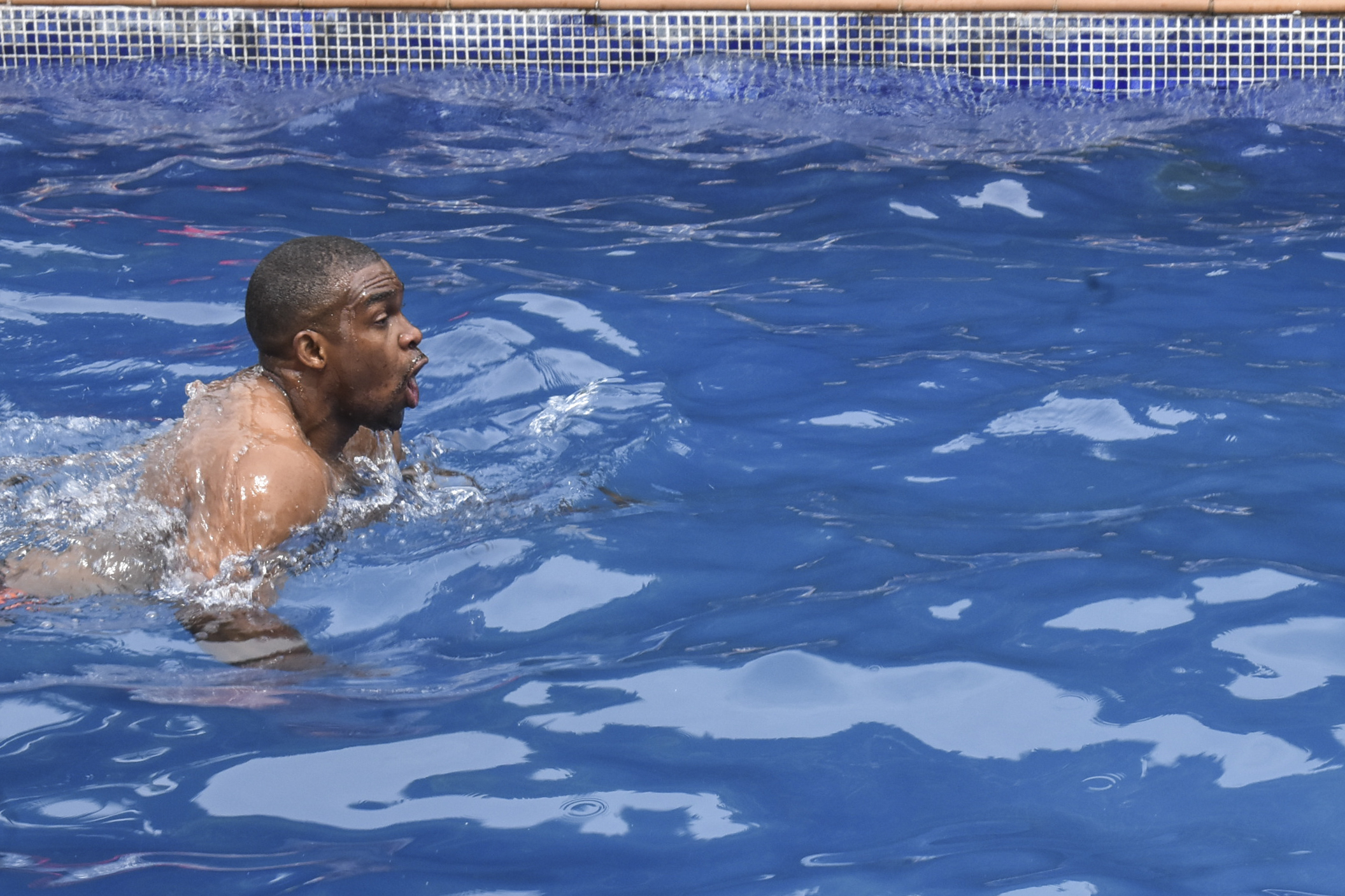 Eric Moussambani swims in a 12m long swimming pool, similar to the one he used to train in while preparing for the Olympics, at the CHN Flat-Hotel in Malabo on September 12, 2020 | Source: Getty Images