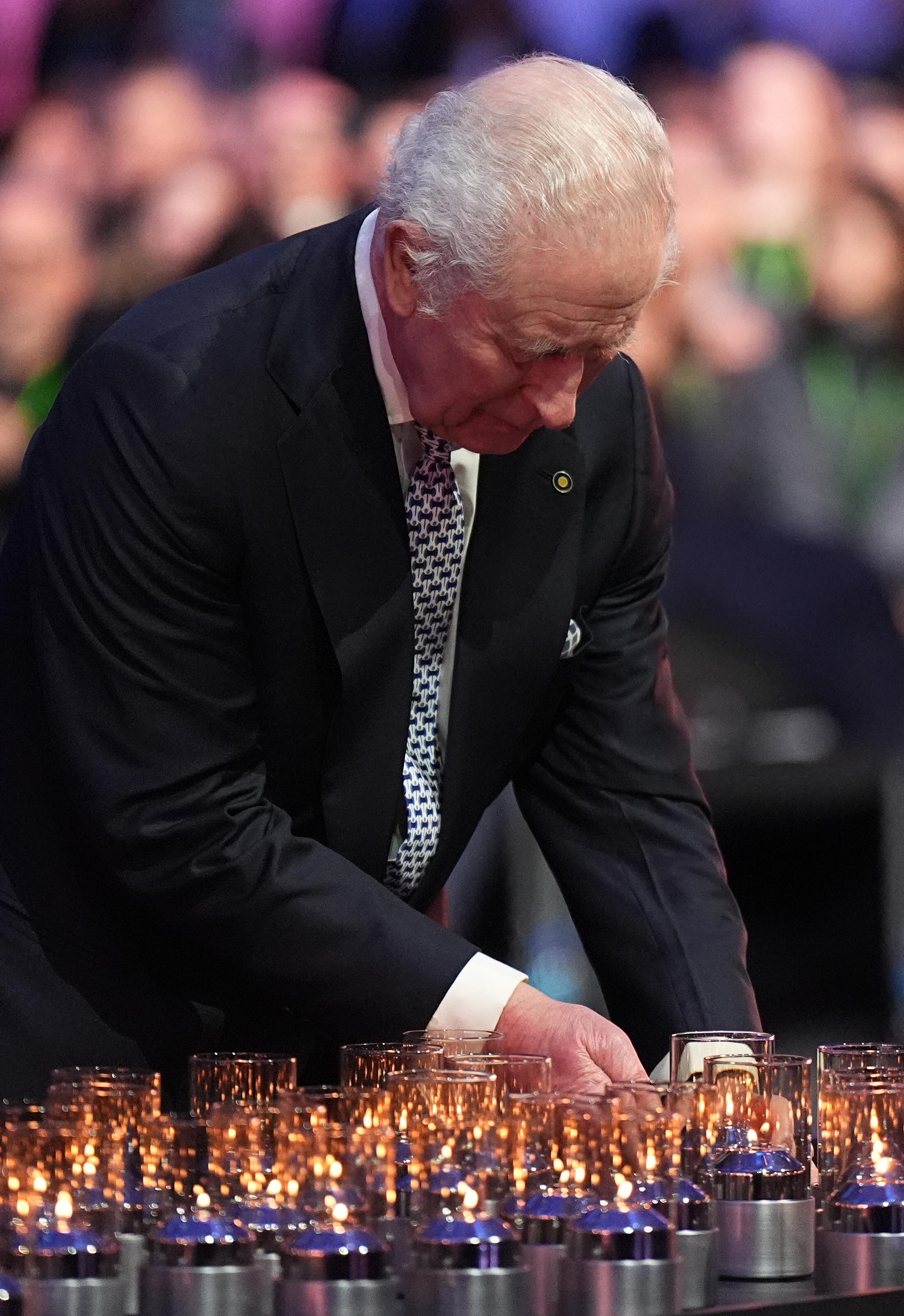 King Charles III lays a candle during commemorations at Auschwitz-Birkenau in Poland to mark 80 years since the liberation of the concentration camp | Source: Getty Images