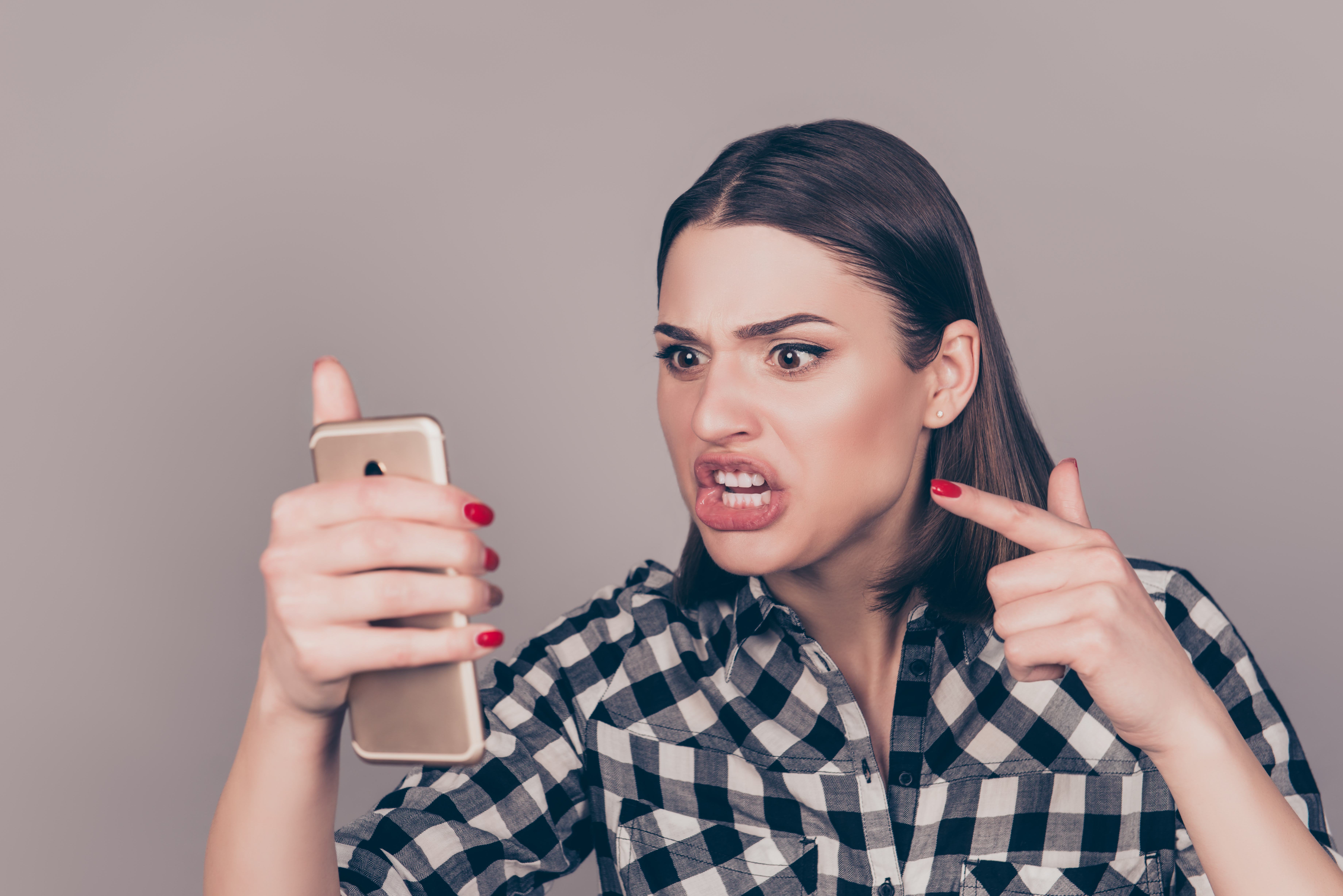 Angry woman arguing on phone at home | Source: Getty Images