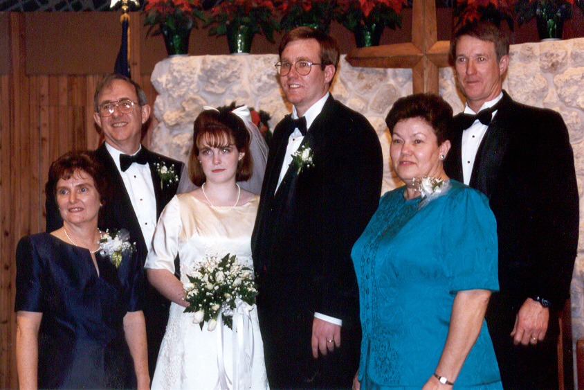 A bride and groom standing with two couples | Source: flickr.com/wjarrettc