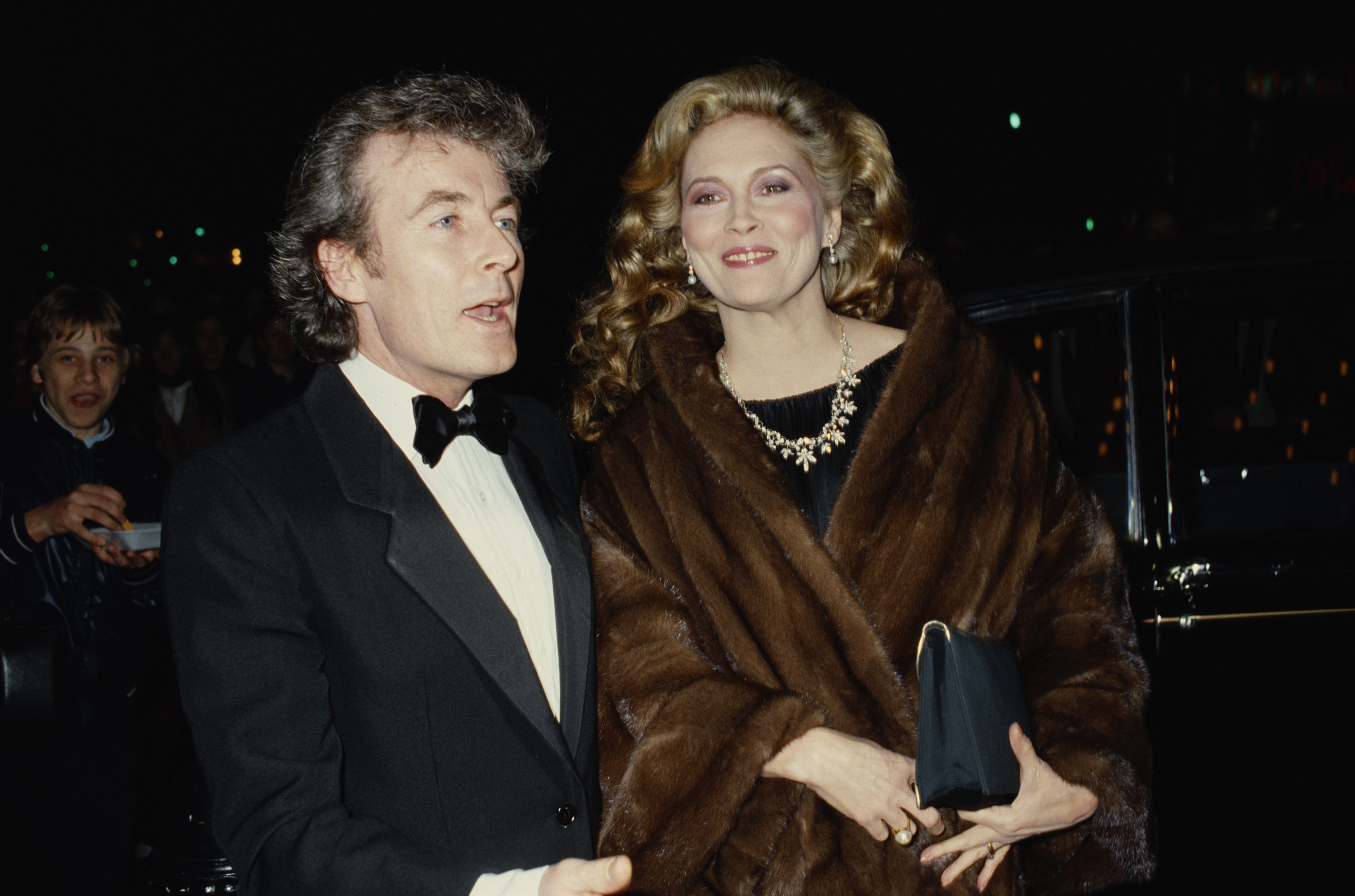 Faye Dunaway and Terry O'Neill attends the premiere of the film "The Wicked Lady" in Leicester Square, London, 1983. | Photo: Getty Images